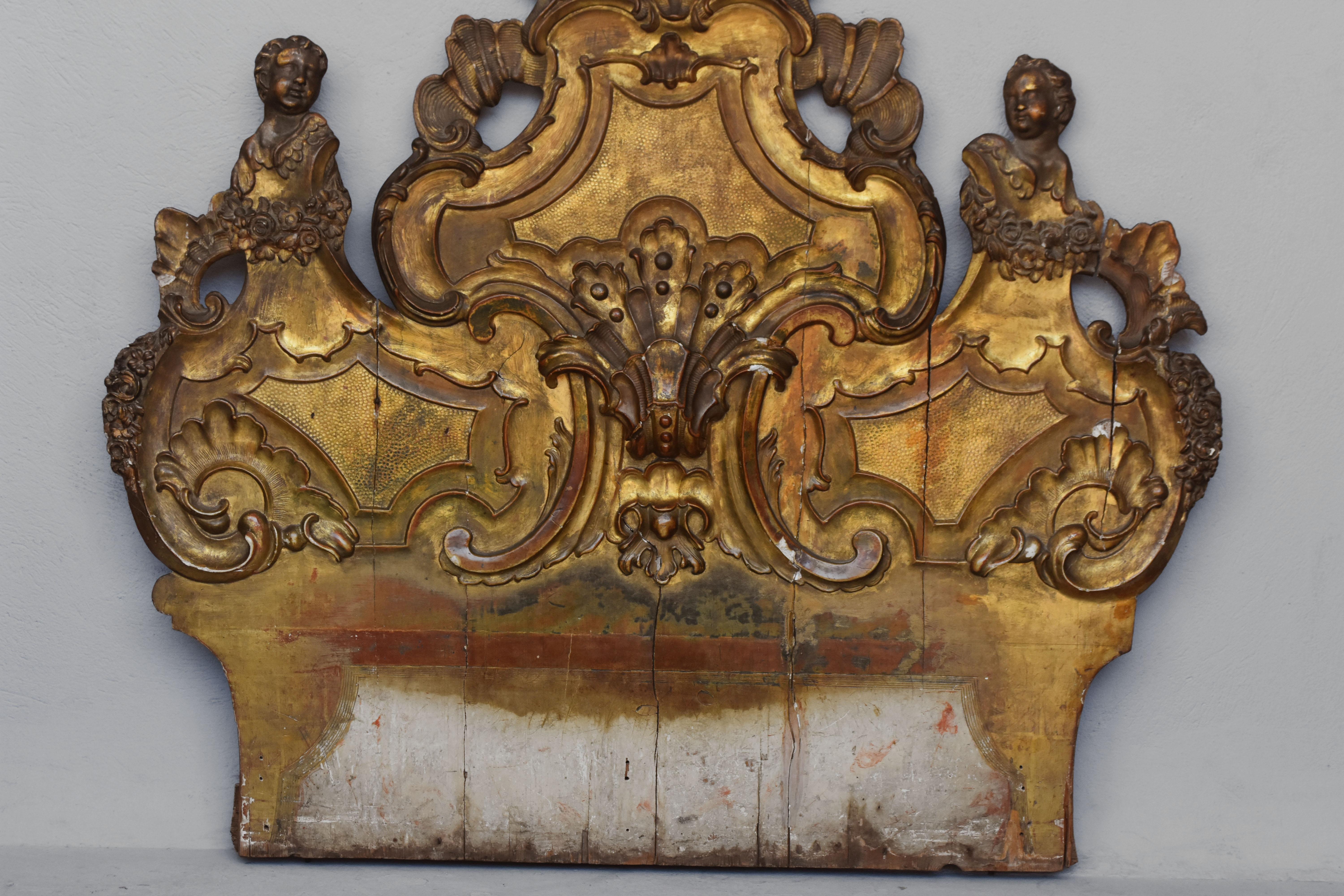 18th wood headboard carved and gilded with cherubs decorations..