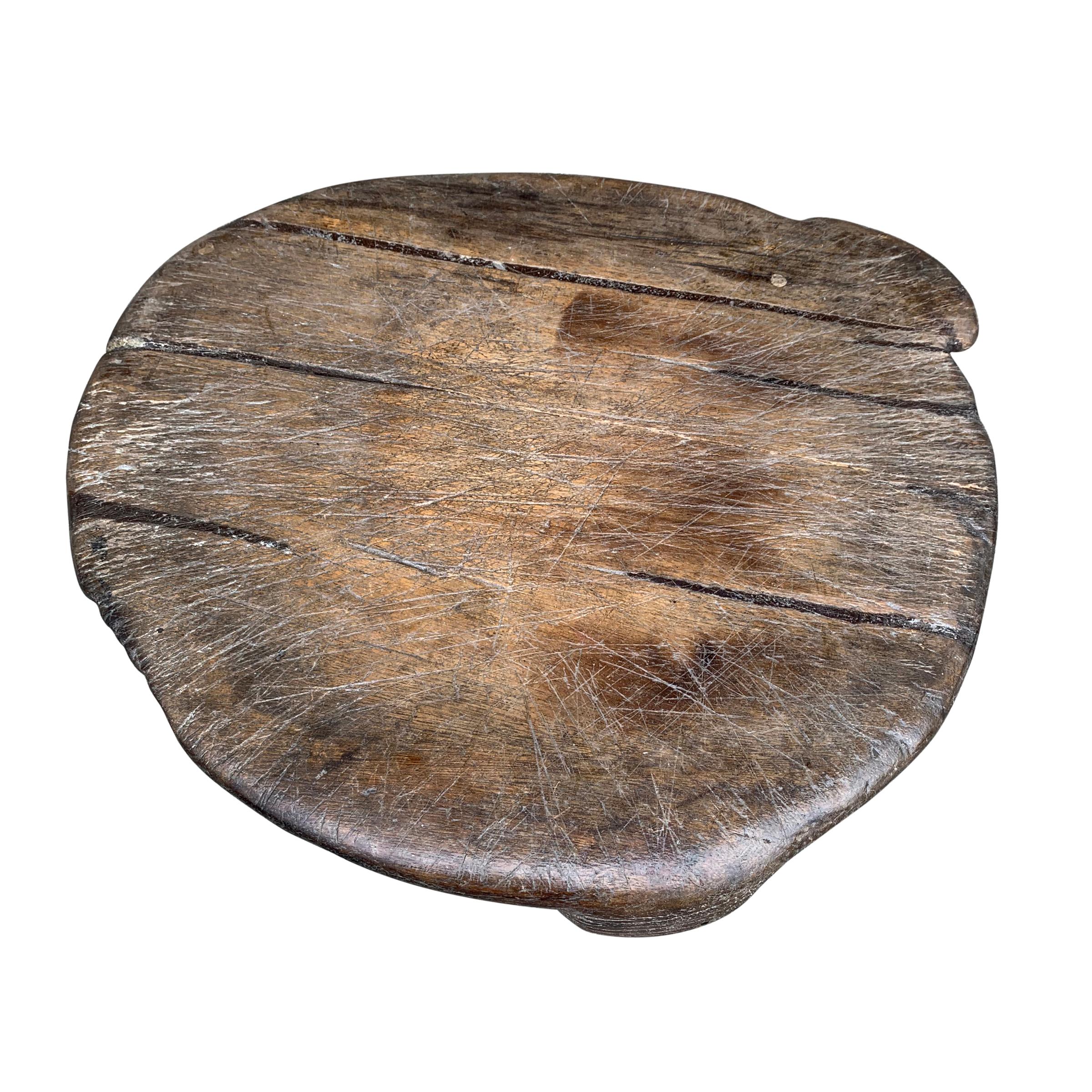 An incredible 18th century Italian wooden pot board, originally used as a trivet to place a pot just off the stove or the fire. The wear and patina are beautiful! It is the perfect elevated platform for serving cheese, charcuterie, or other festive