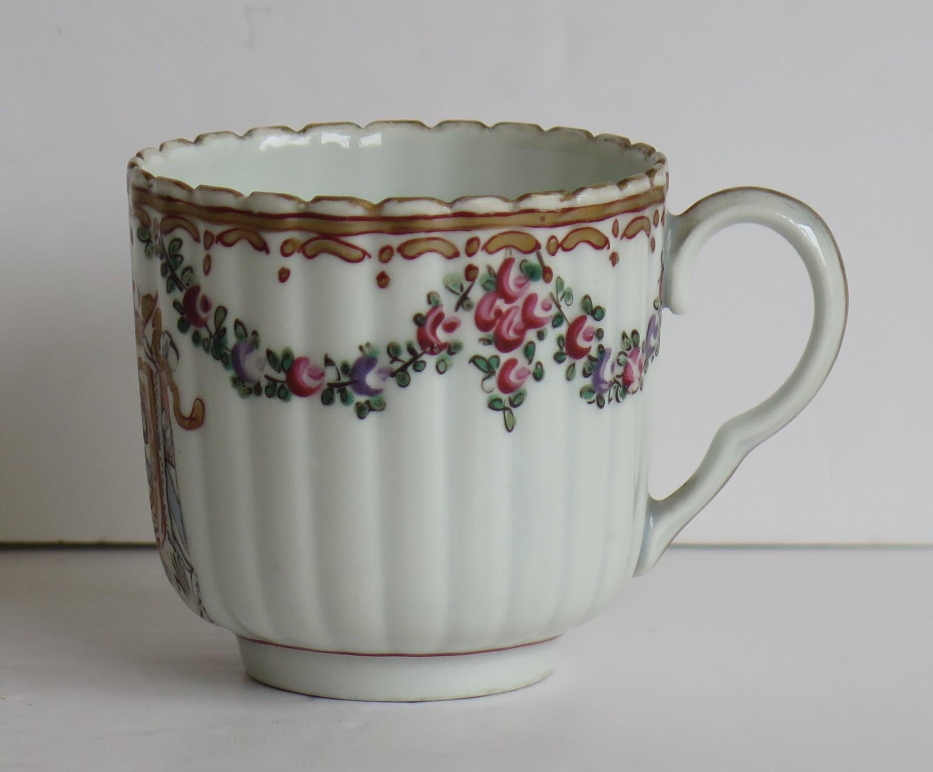 This is a high quality coffee cup in a hand enamelled and rare gilded Armorial pattern made by Worcester during the late 18th Century, circa 1795

The coffee cup is well potted and nominally parallel, with 25 vertical flutes and a loop handle