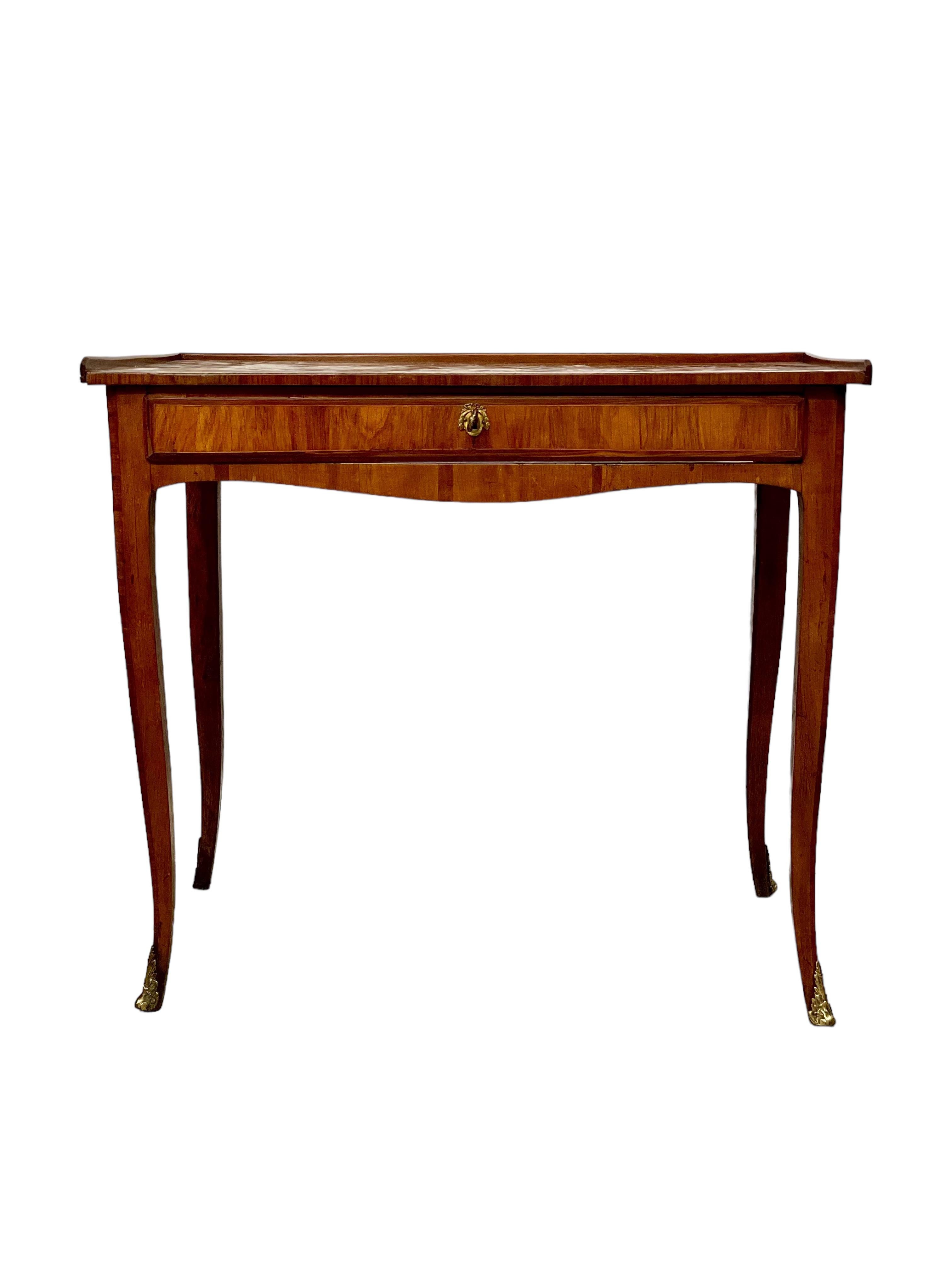 A dainty and very stylish veneered 18th century writing desk, with a slim and elegant frieze drawer and gorgeous cube parquetry decoration to the top surface. The legs are very slightly curved outwards, and are beautifully finished with a fine