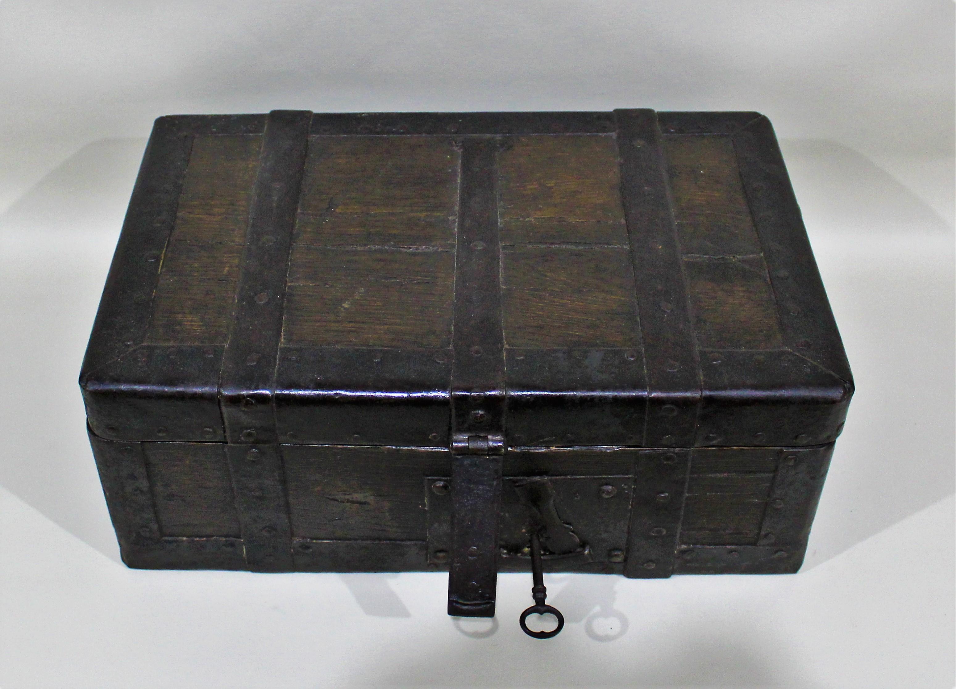 Antique 18th century wrought iron and wood strong box with hand forged hardware and lock.
