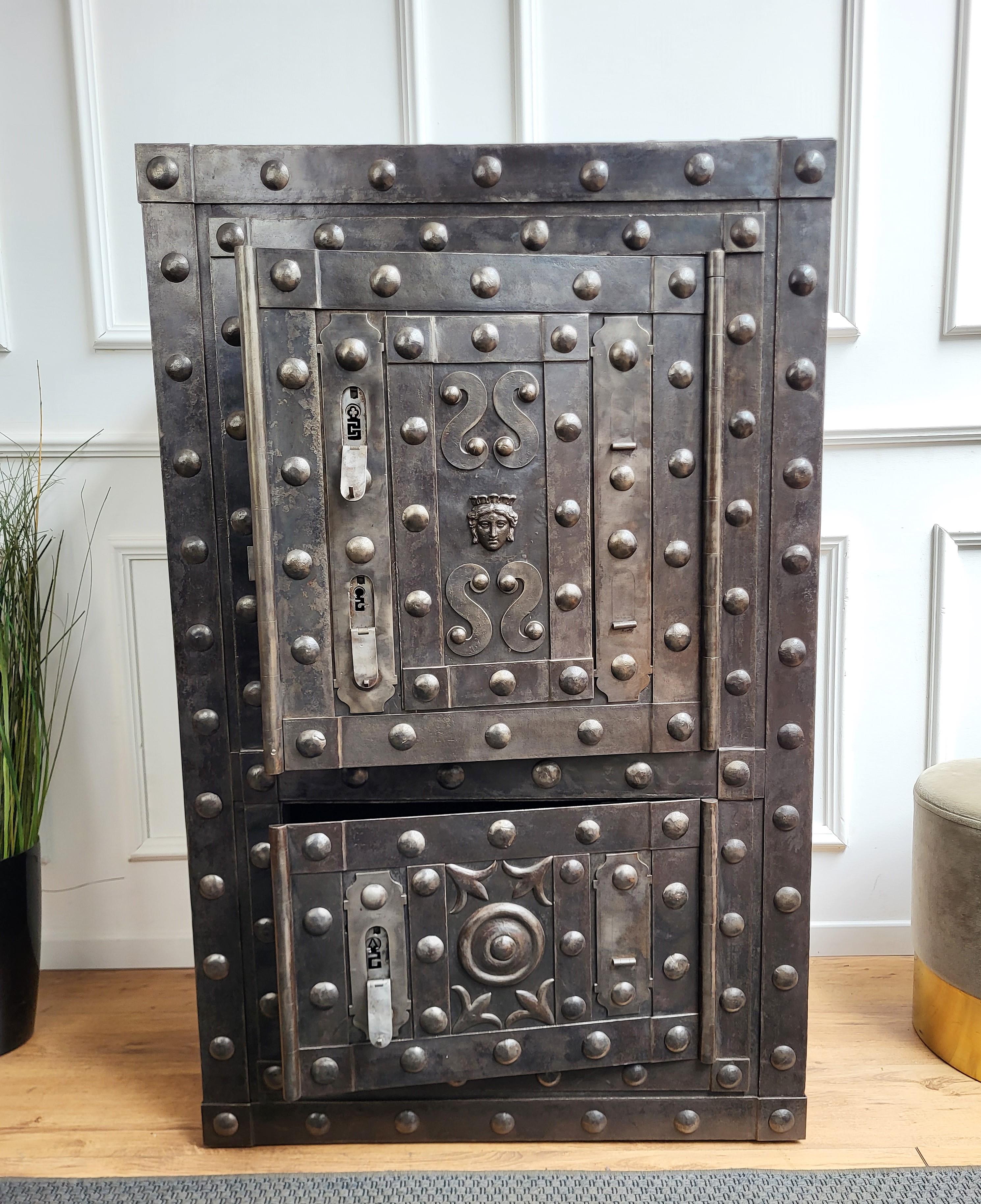 Beautiful and very rare example of early 18th / late 17th century Italian master blacksmith craftsmanship, this antique studded safe with typical all-around hobnails and great wrought iron details, has a fabulous central facial decor with side