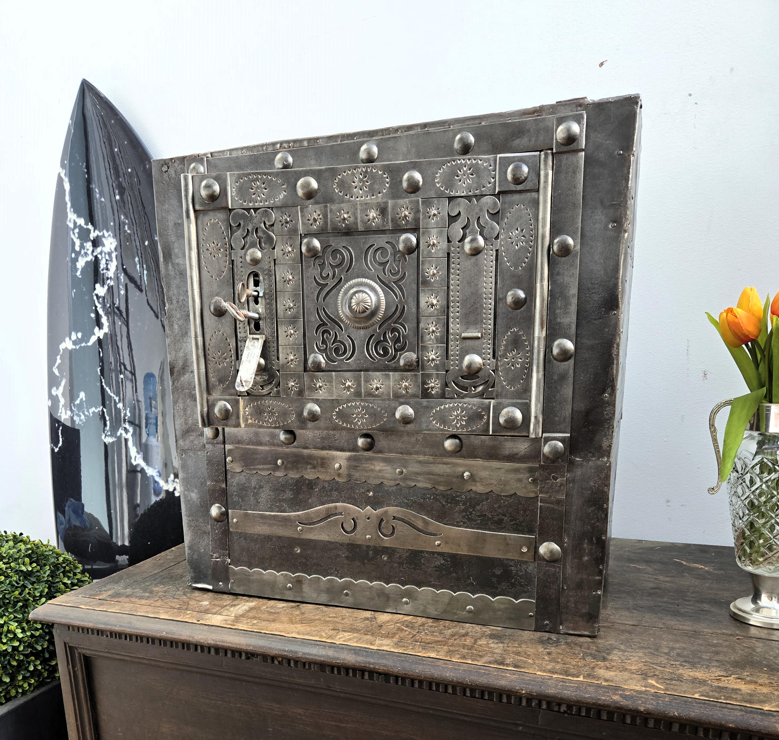 Beautiful and rare example of late 18th century Italian master blacksmith craftsmanship, this antique studded safe with typical hobnails and great wrought iron details, probably from the Piedmont region, has a great metal color with patina of time
