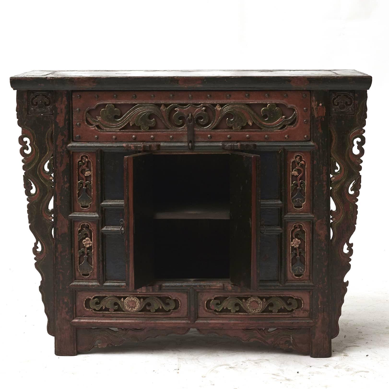 18th Century sideboard or side cabinet.
Decorated with fine ornate relief carvings on front and drawer and carved spandrels at each side that taper down to the feet.
Original polychrome lacquer. 
The sideboard is untouched in original condition,