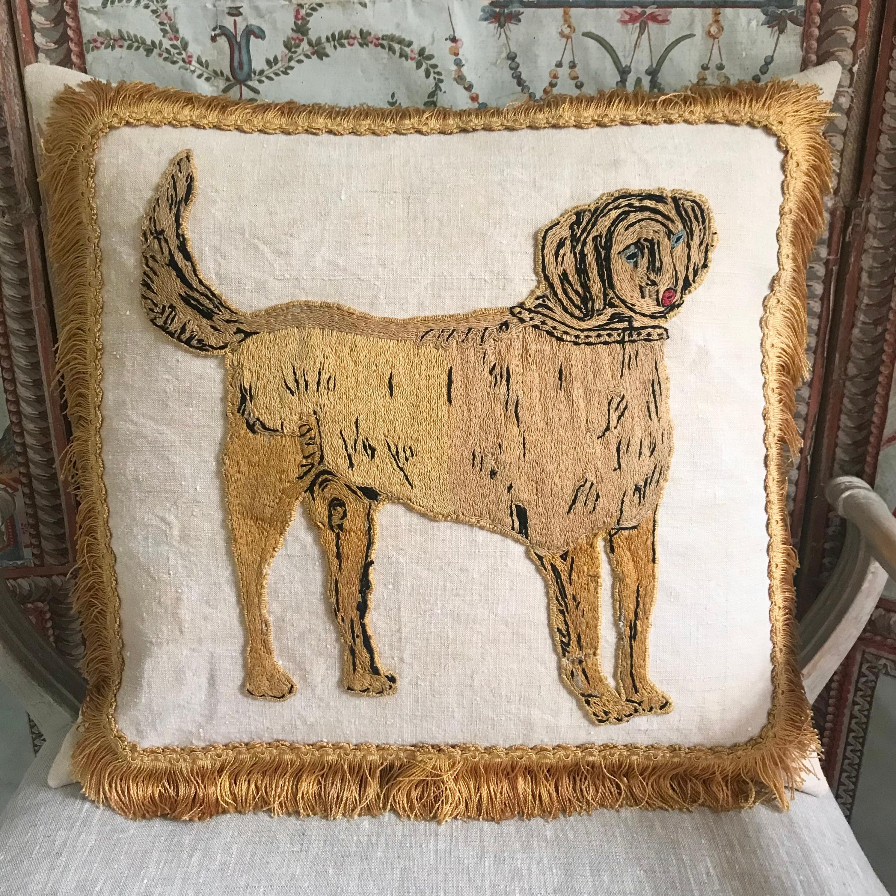 A rare 18th century embroidery appliqué of a dog hand stitched onto antique linen then embellished with an antique silk fringe making a very unusual and beautiful cushion - plain antique linen to reverse and a soft luxurious down feather inner - a