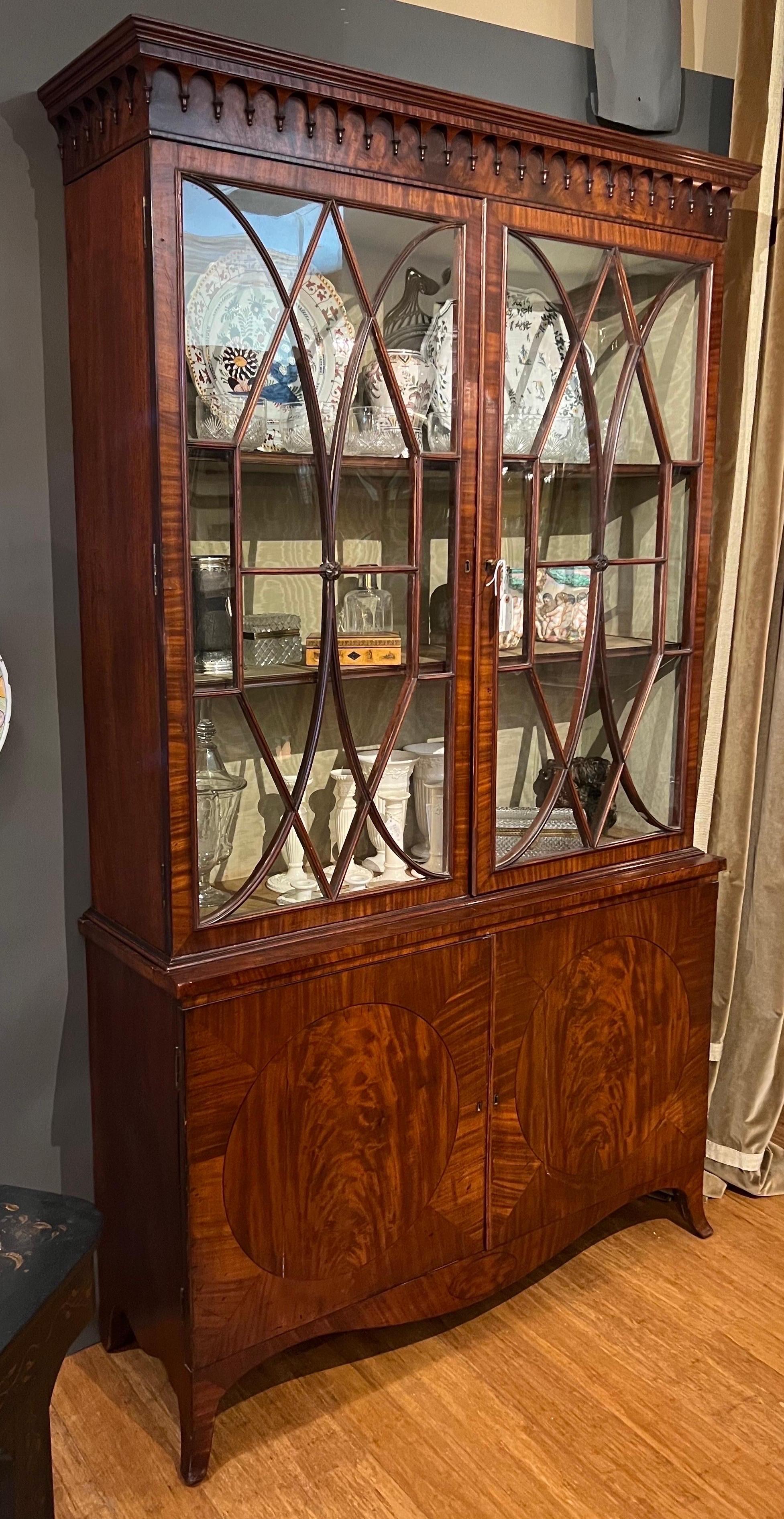 18th- early 19th century Georgian mahogany china or book press on original French feet. Two part cabinet form- bottom inlaid doors open to reveal linen slides. Very impressive piece with wonderful proportions.