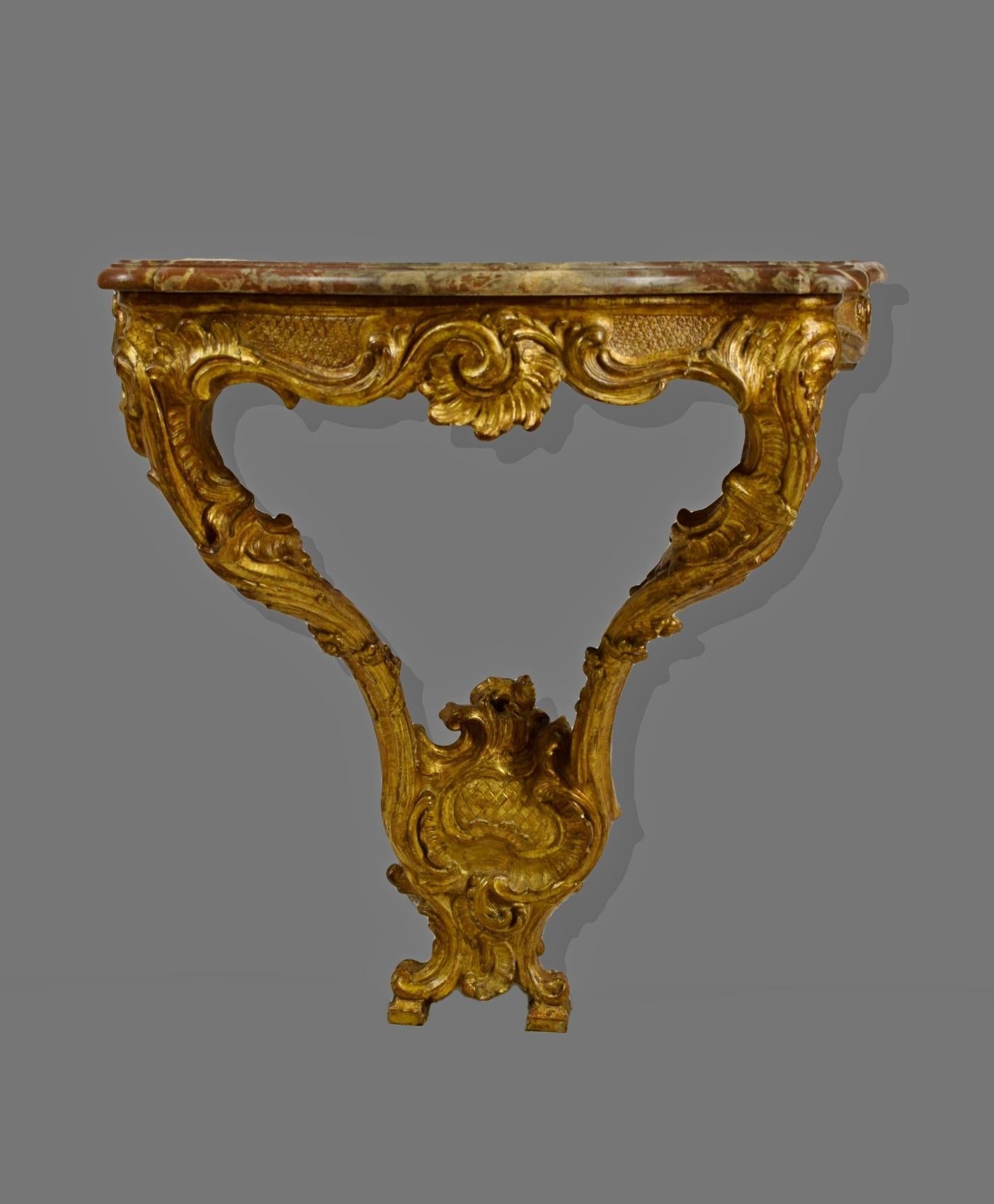 18th French Louis XV giltwood teardrop table console

This small console d'applique, was made in France in the 18th century, Louis XV. The richly carved and gilded wooden structure, in a wavy line, has a refined 'teardrop' shape, consisting of two