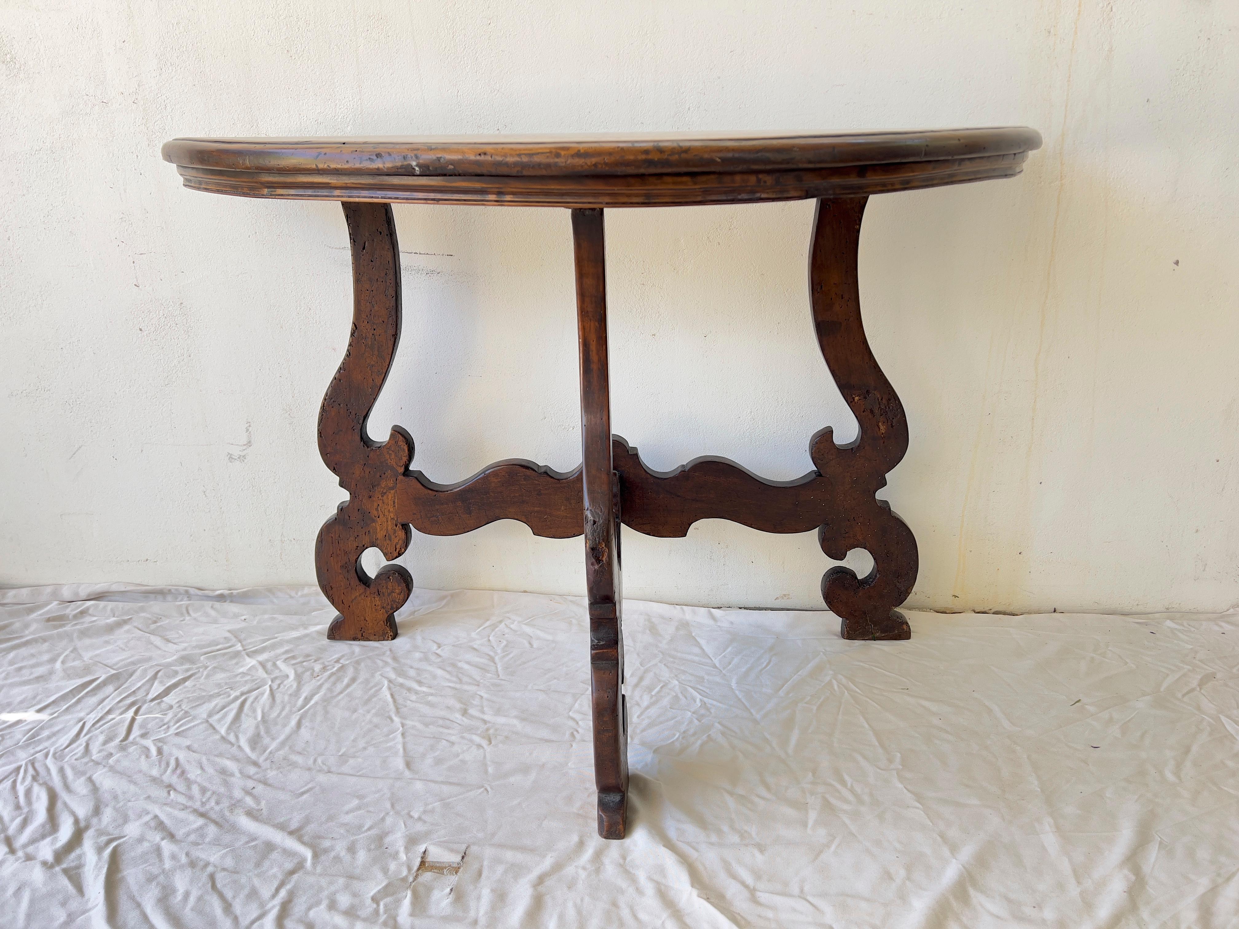  Italian Baroque style  walnut demi lune console table from the 18th century, with semi-circular top, carved legs and cross stretcher.  this Baroque table or  console is in excellent condition  with a wonderful grain, The half-moon rounded tops have