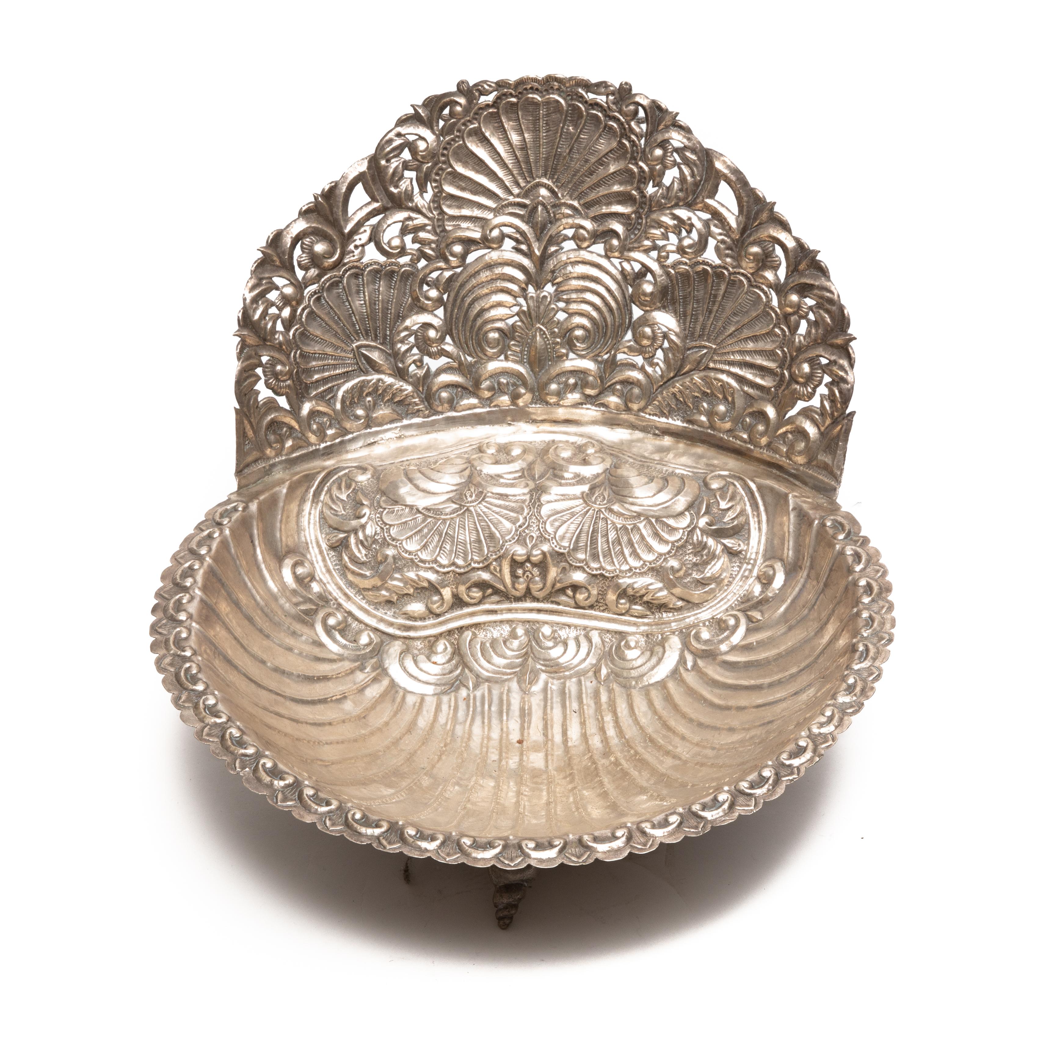 18th century Spanish colonial silver baptism dish. This large bowl is designed with a scalloped rim, repousse scroll and shell decorations and shell feet, unmarked, 46.65 oz. T., 11 x 20-1/2 x 17 in. Note: This item descended in the family of Manuel