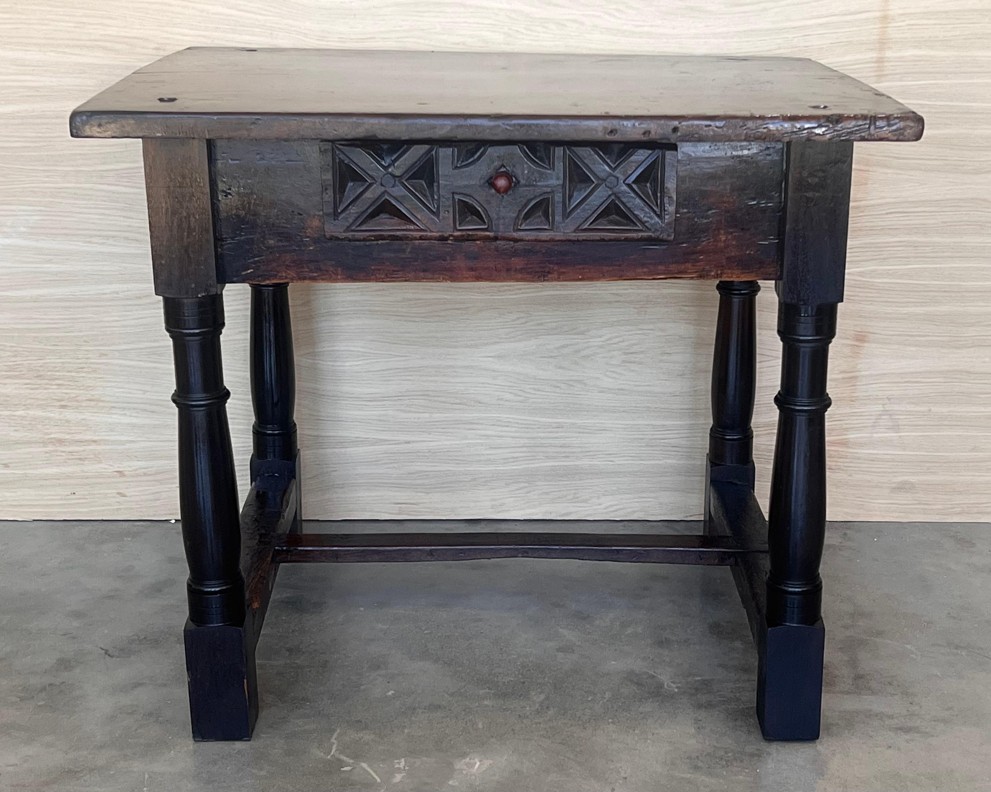 This  Spanish 19th century features a beautiful one plank rectangular top over a carved drawer featuring slightly different hardware, is adorned with geometrical motifs and their original handmade drop pull.
Black ebonized walnut in all the