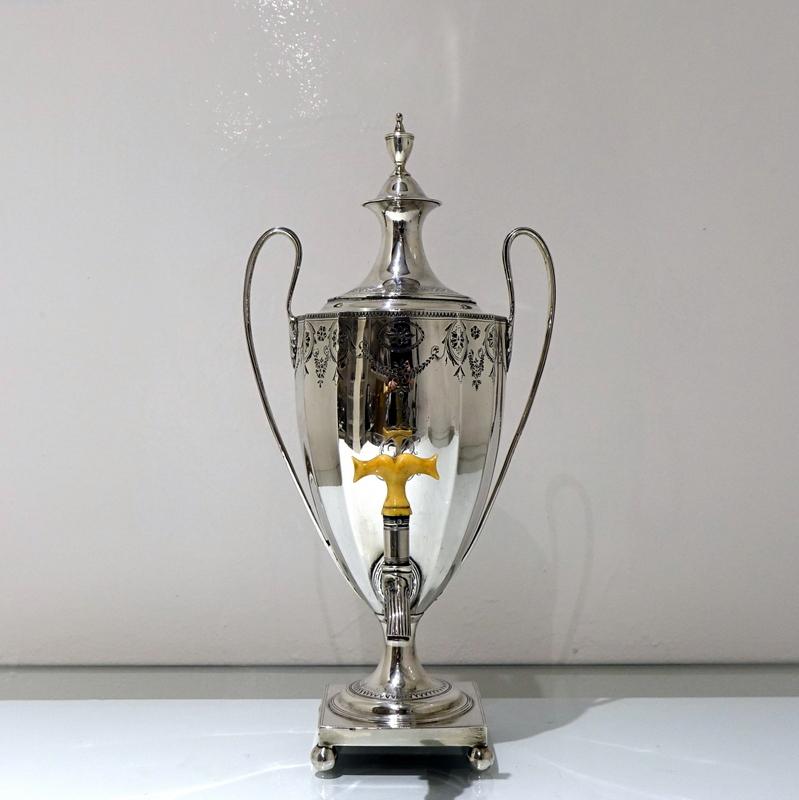A fine Georgian silver coffee urn decorated with intricate bright cut engraved motifs of floral hanging garlands and shielded rosettes to the upper section of the body.  The foot has additional bright cut engraved decoration for lowlights and sits