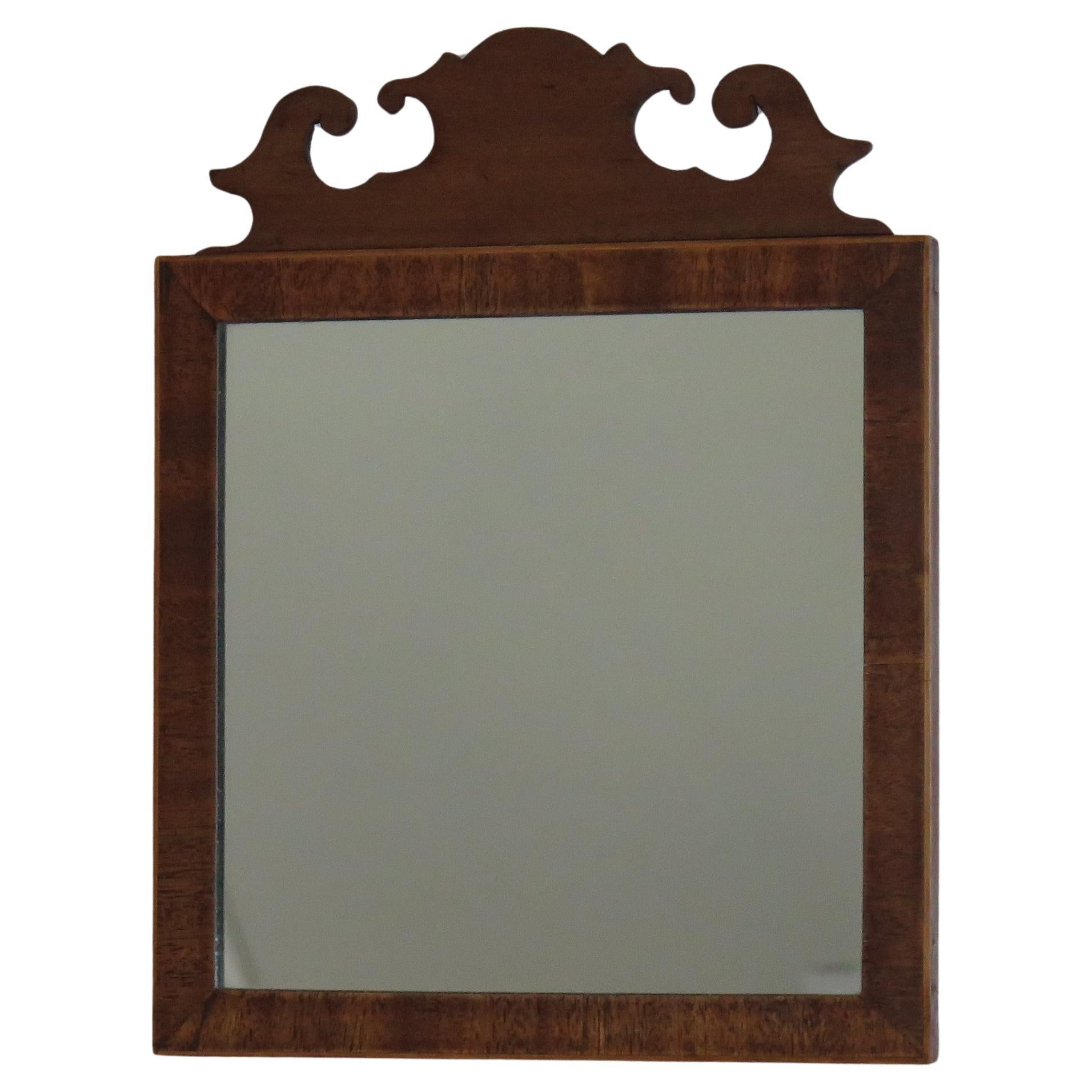 This is a fine quality English Wall Mirror of small proportions, dating to the second half of the 18th century, George 111rd period, circa 1770.

The mirror is well constructed with a hardwood veneered frame, veneered on pine. This mirror has many