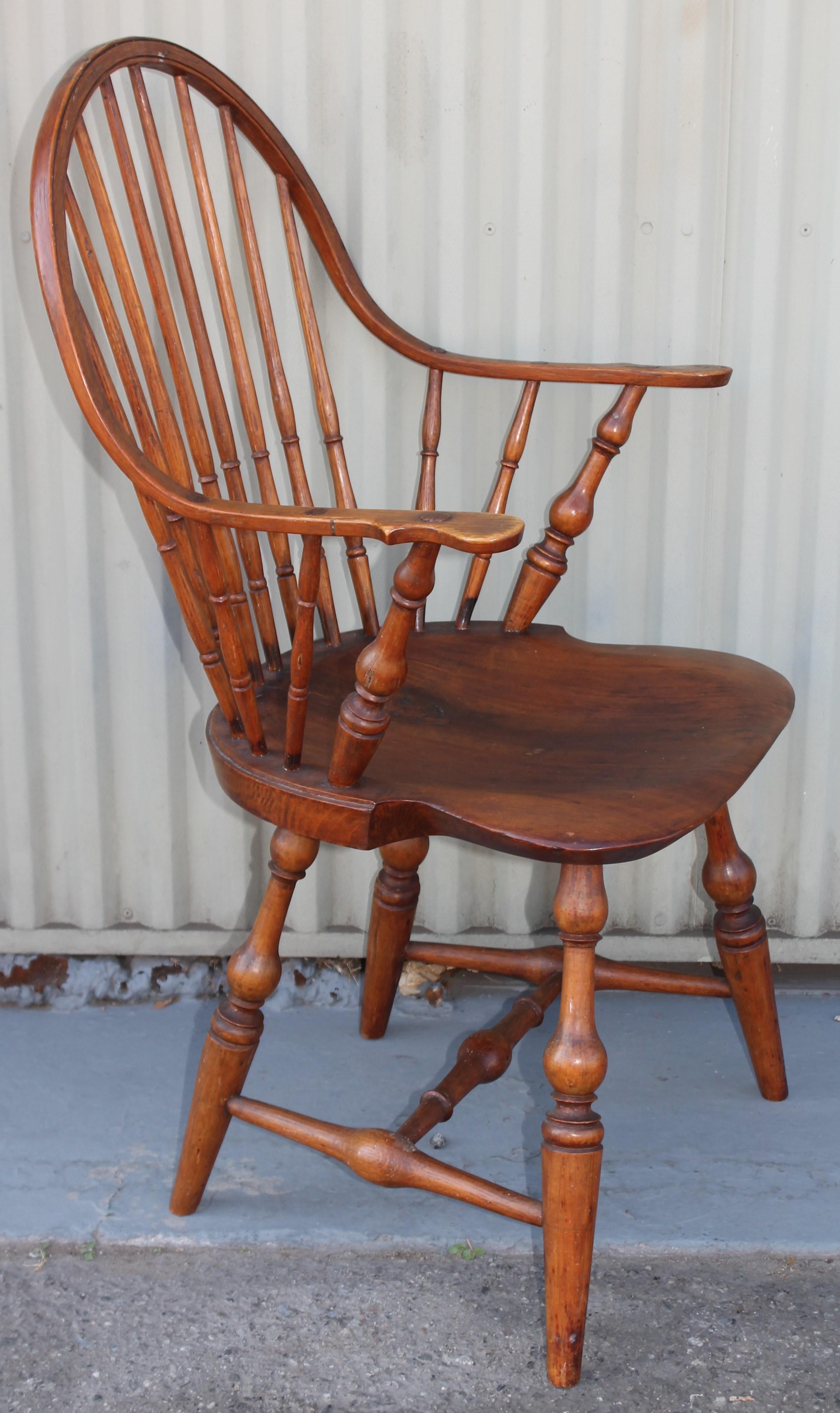 This 18th C extended arm sack back Windsor is from New England. This comes to us from a private collection.This is stamped Dimes underneath the seat.
 