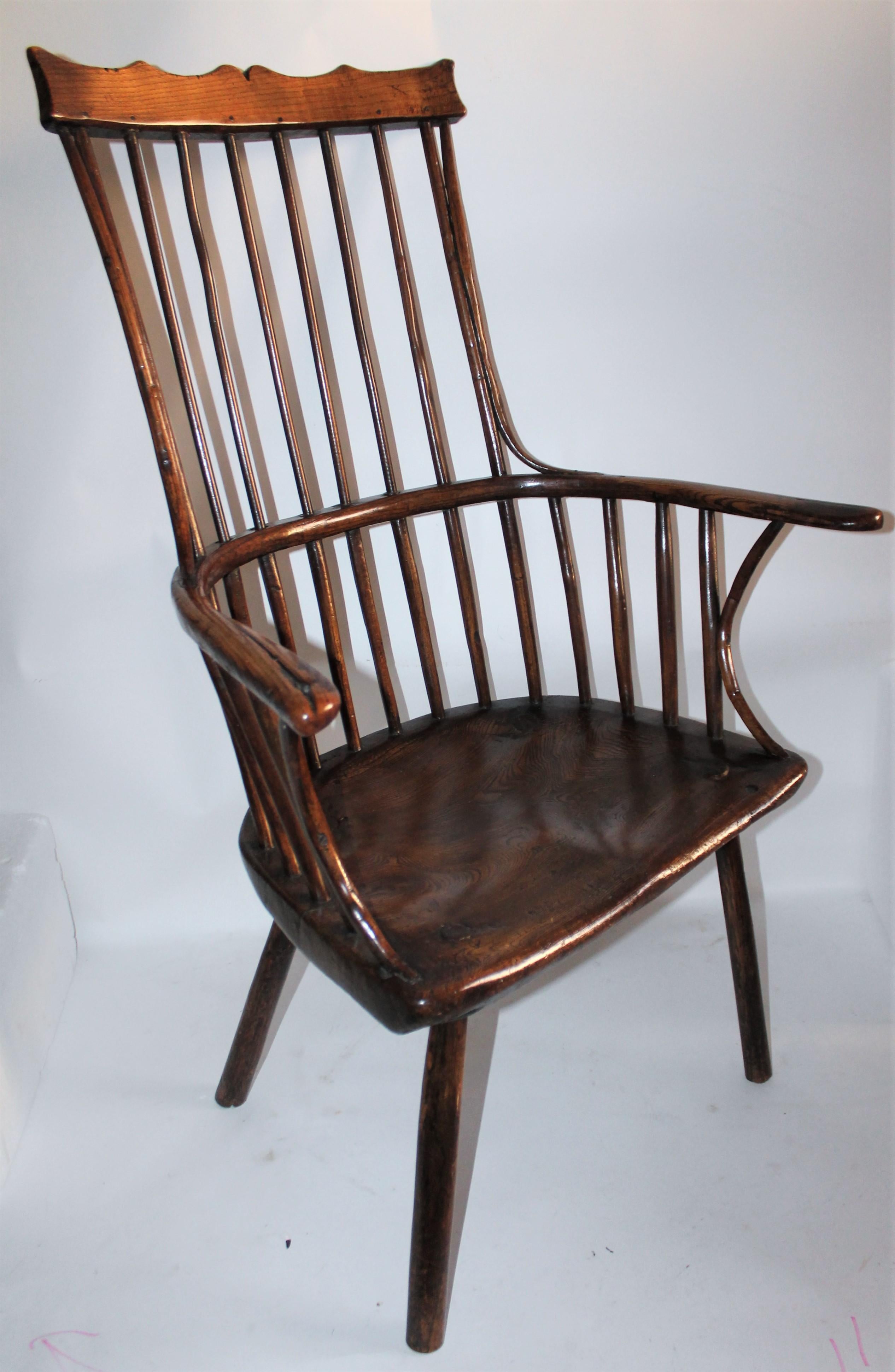 18th century English extended arm Windsor chair and a high back and fantastic patina. The condition is very good and such great form. This is such a rare and fantastic form.