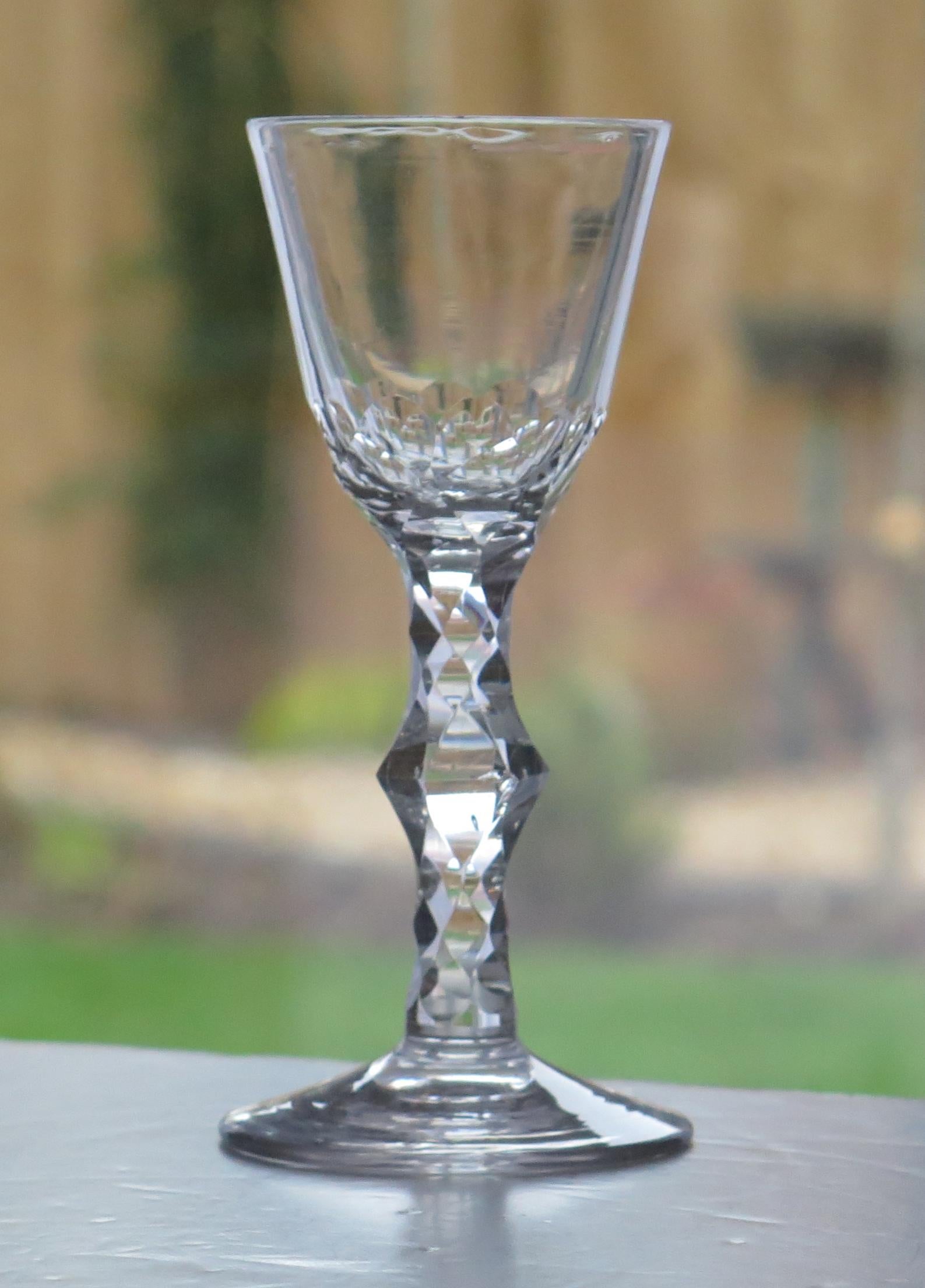 This is a very good hand-blown, English, Georgian, wine drinking glass with a facet cut stem, dating from the 18th century, circa 1785.

These glasses are very collectable. It is made from English lead glass which is relatively heavy and has a