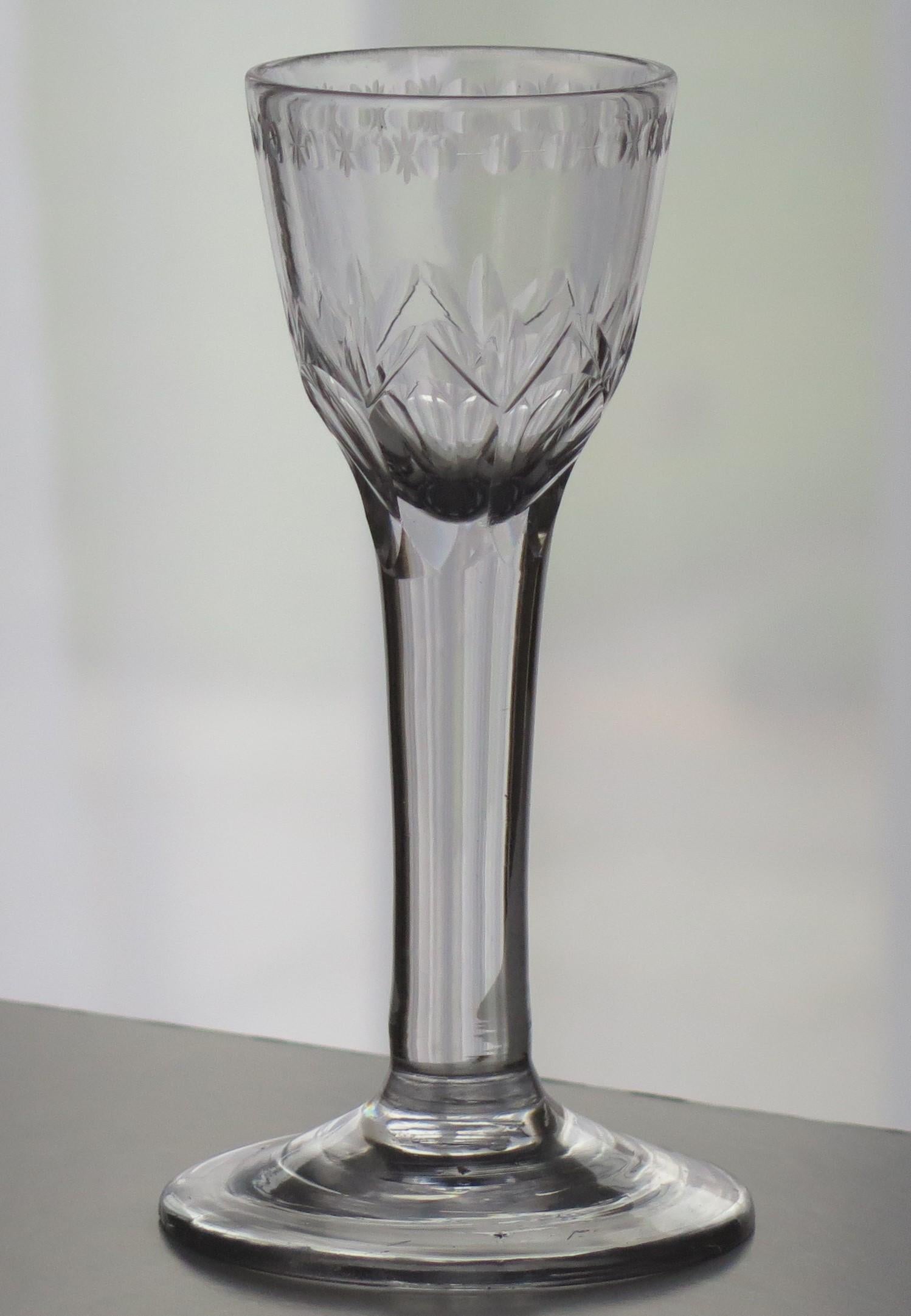 This is a very good hand-blown, English, mid-Georgian, Wine drinking glass with a round funnel (RF) engraved bowl on a solid stem, dating to the middle of the 18th century, circa 1760.

These glasses are very collectable. It is made from English
