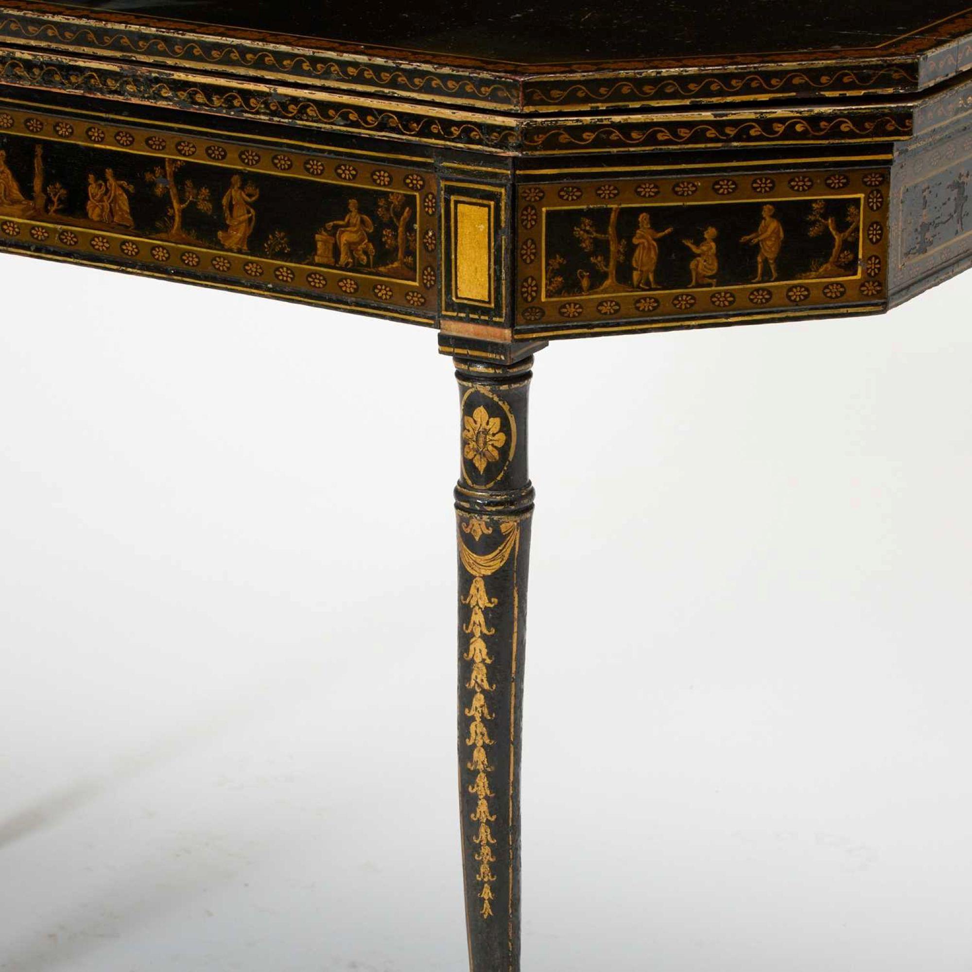 A hand painted and Japanned game table with beautiful gilt decoration from the 18th century.  Octagonal in shape and lined with an exceptional  needlepoint lining depicting playing cards and flowers.  An absolutely stunning piece with gorgeous