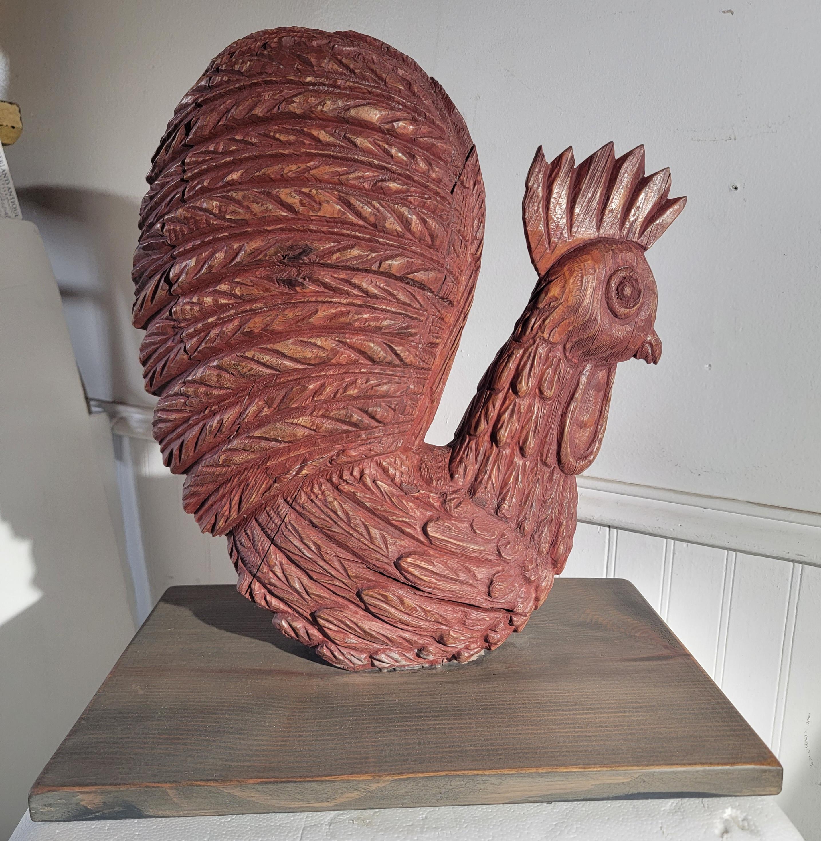 This fine folk art 18thc hand carved rooster ,sculpture sits on a board /stand.This fine sculpture has a wonderful red wash painted surface & several shrinkage cracks from natural age.This was found in New England estate.