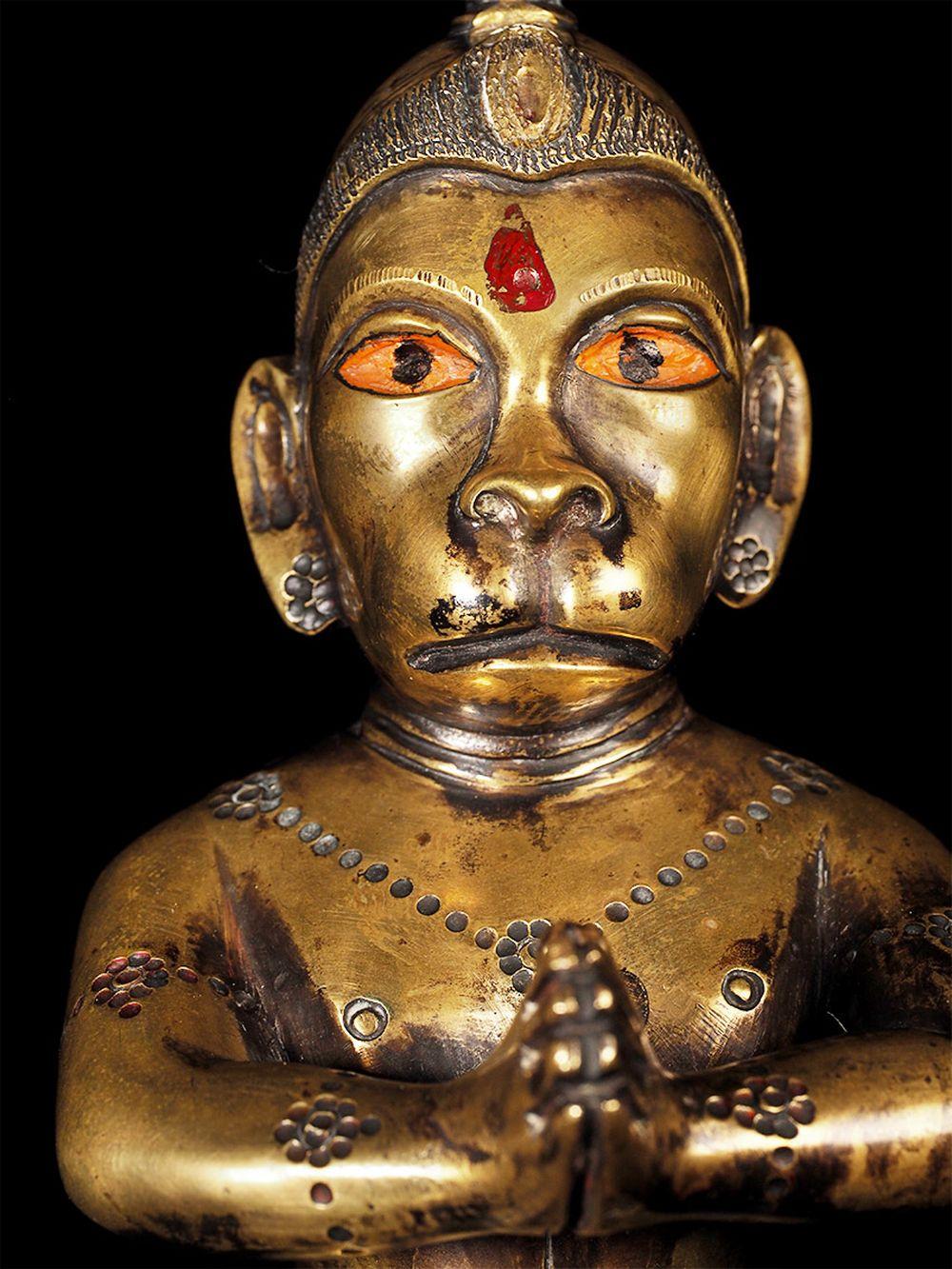 Rare and supremely beautiful 18thC Hanuman cast of a special alloy that may contain precious metals. Red band around the base. There may have been an original red color that wore off in spots that were replaced over time. The eyes and minute remains