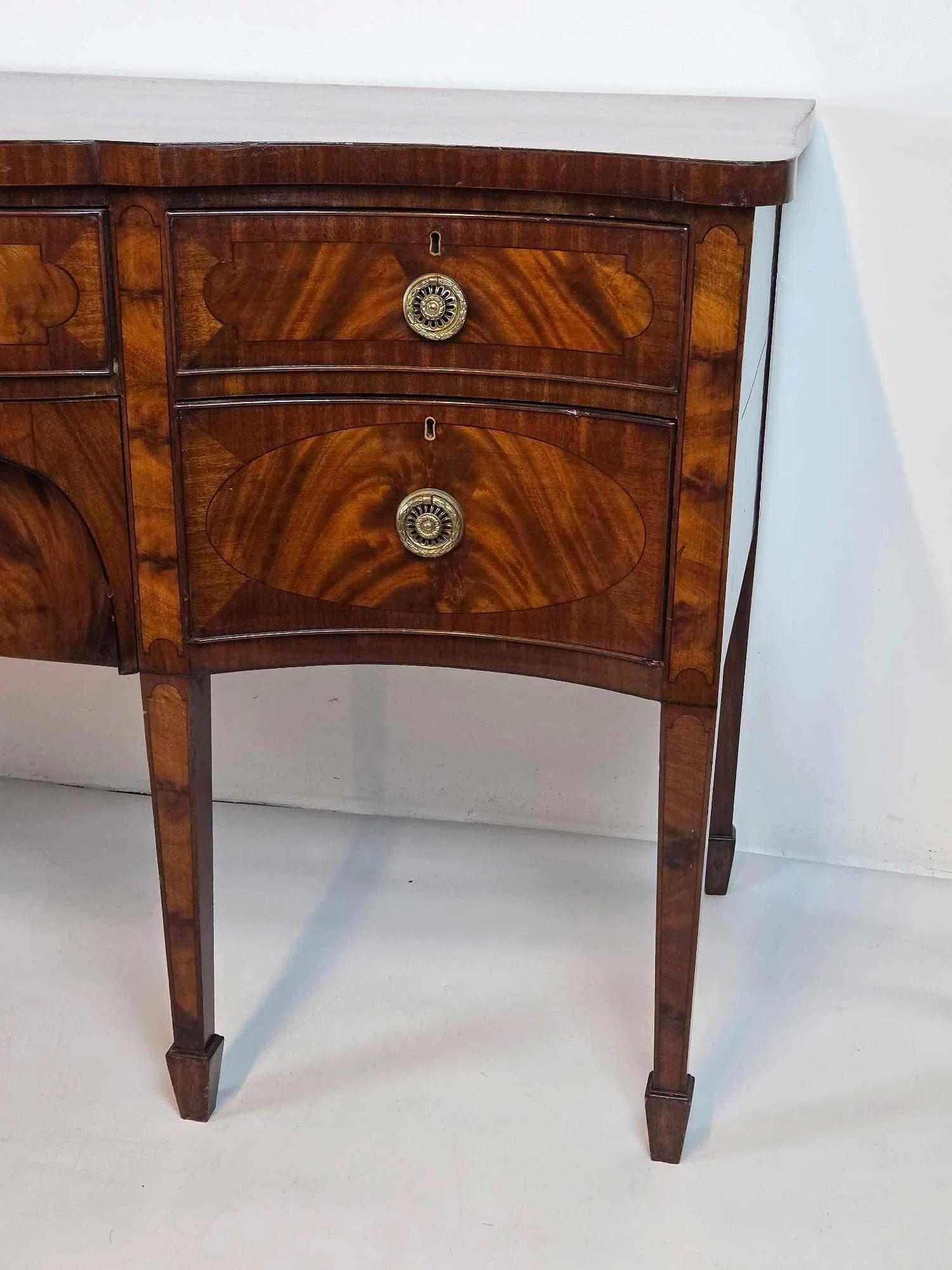 18th Century (George III) inlaid mahogany sideboard with elegant bow front.  Stunning period piece in beautiful condition that would  elevate any room.  Some minor scratches and abrasions.  Has old hardware, likely replacements. Scarce piece.   