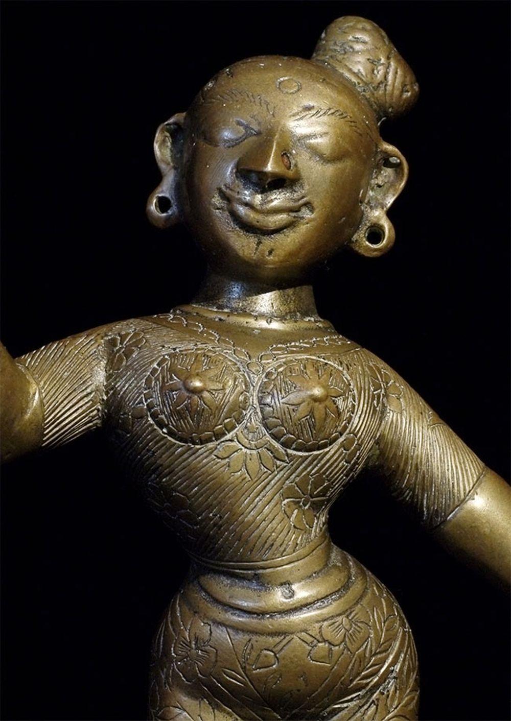 Large antique solid cast South Indian female deity covered with well incised elaborate design. Stands 8.5 inches tall, bottom diameter is 4.5 inches. Heavy. Big beautiful smile. Good age. - 6706.