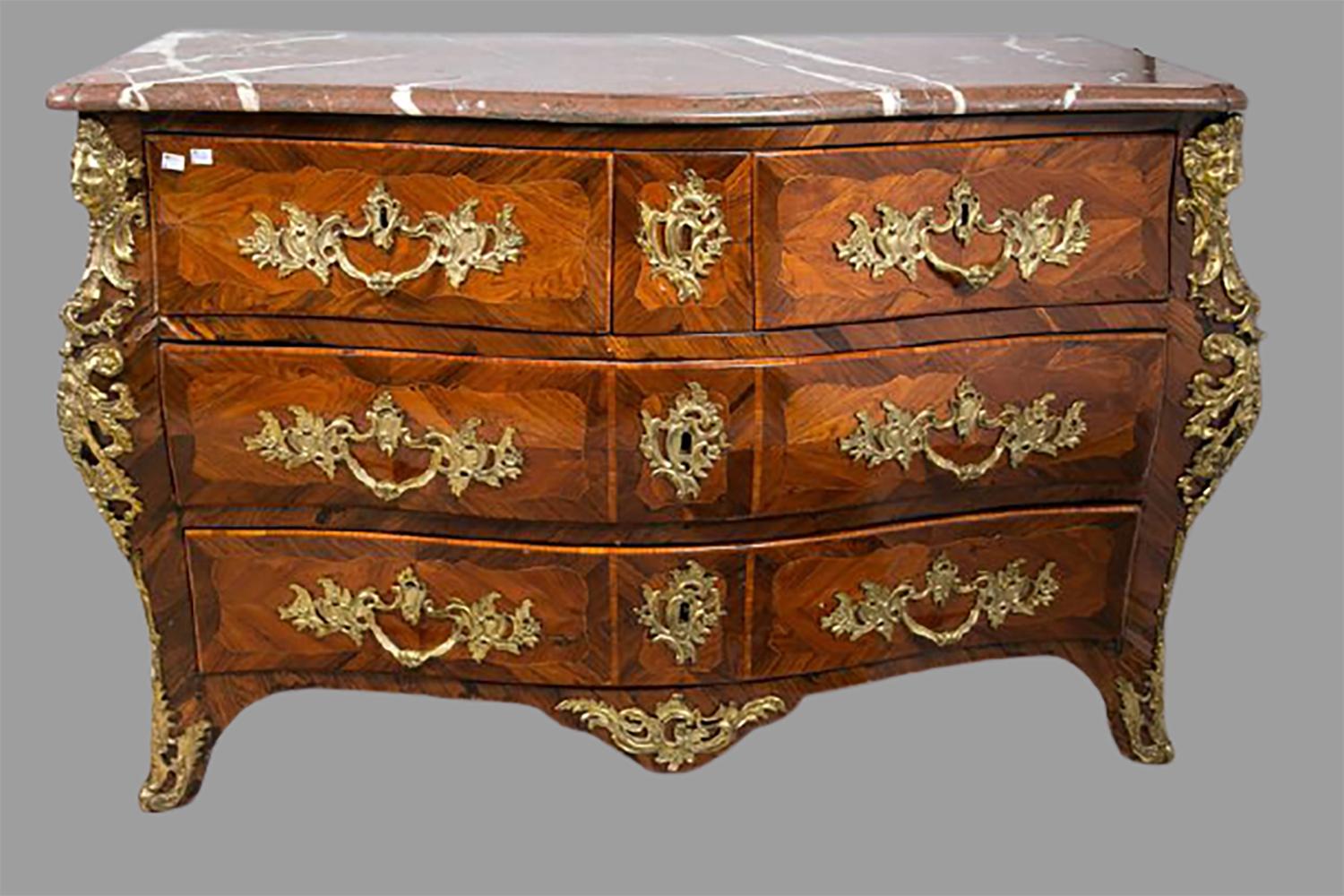 18th century marble-top three-drawer Regence commode. This spectacular Regence commode has a case that is signed L. Dumay in three different places. Having satinwood kings wood veneers this outstanding commode has a solid wood bombe case with full