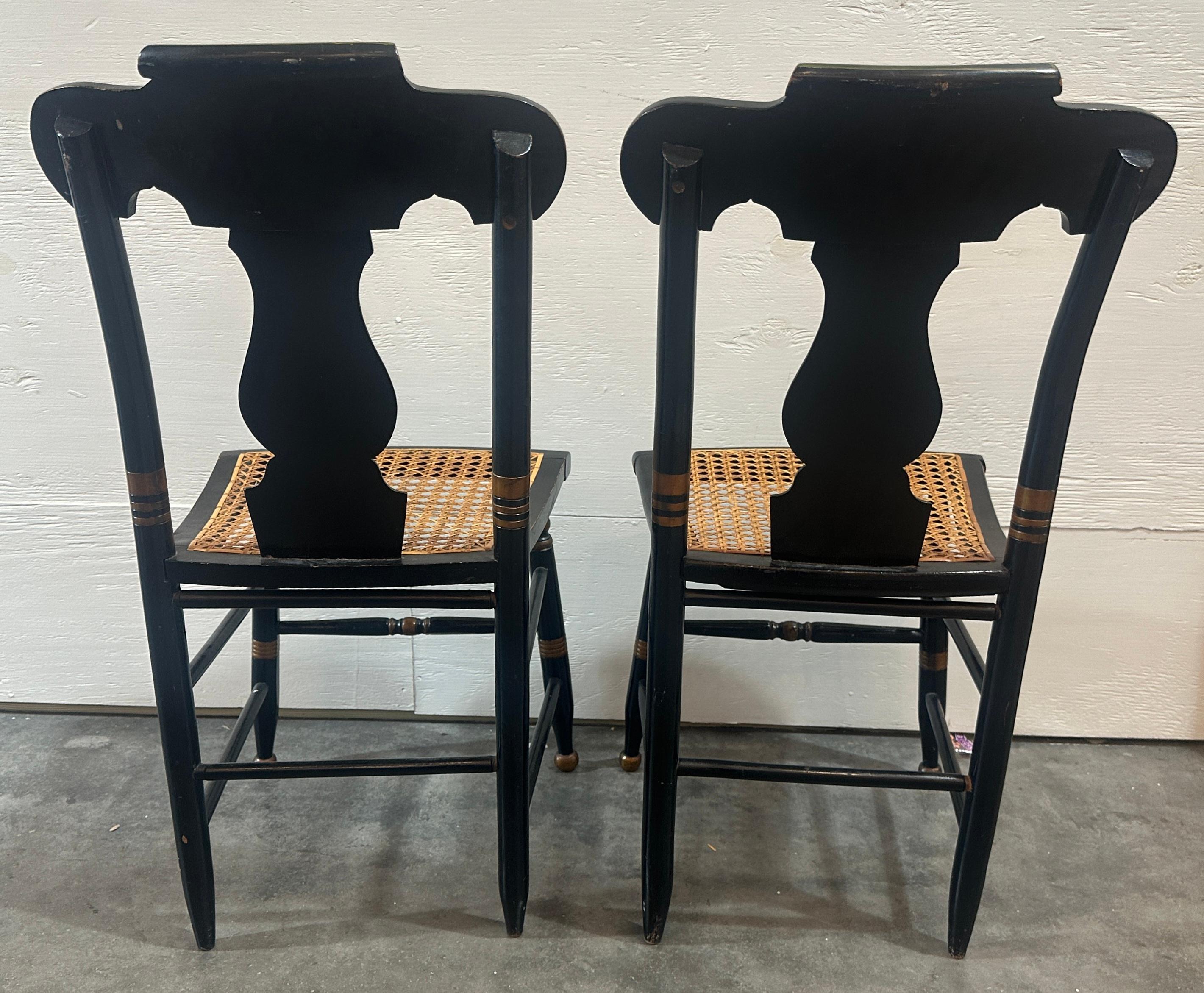 Amazing pair of comfortable chairs. Original stencil work to the frame of the body showing a fruit bowl with cherries to each side of the fruit bowl. The stem of the chair where the back rests has an ornate vase stencil work. Such beautiful hand