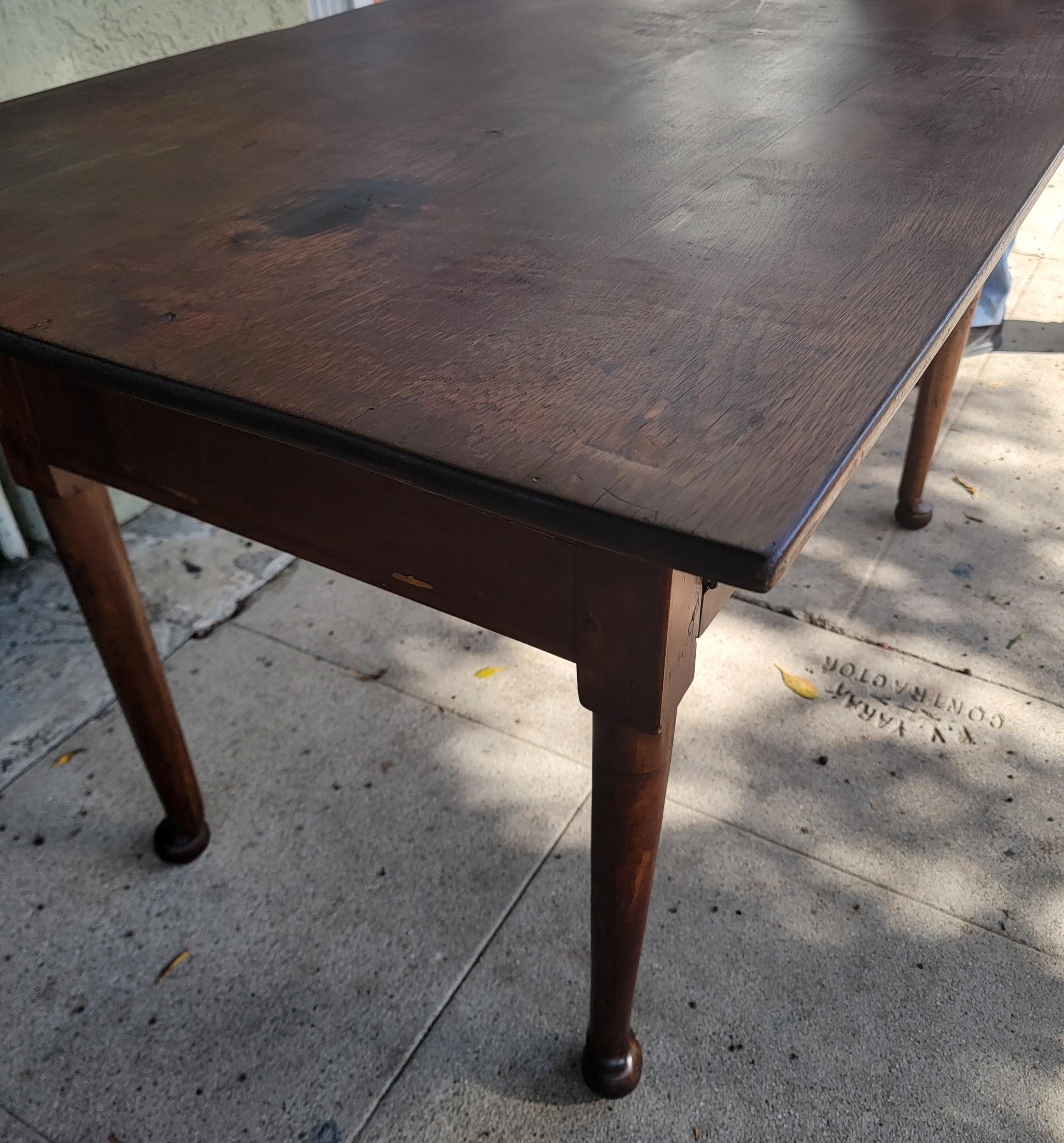 This 18thc tavern table is made from Walnut and with Queen Ann legs and pad feet. This table has wood pegs and dovetailed drawers. The table has a fine patina and condition.