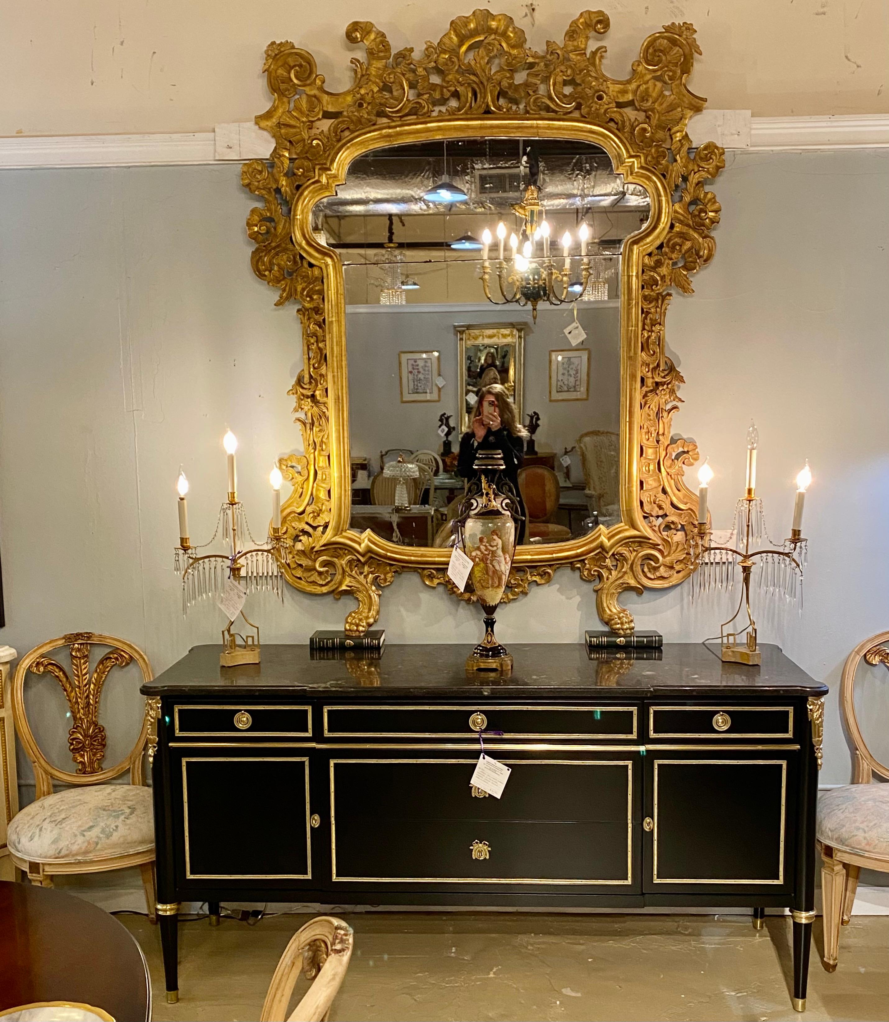 Early 19th century giltwood mirror. This monumental over the mantel (fireplace), wall or console mirror was removed from a Greenwich CT Mansion having been purchased in Sotheby's NYC, known at the time as Park Bennett, in 1961. Part of an extensive