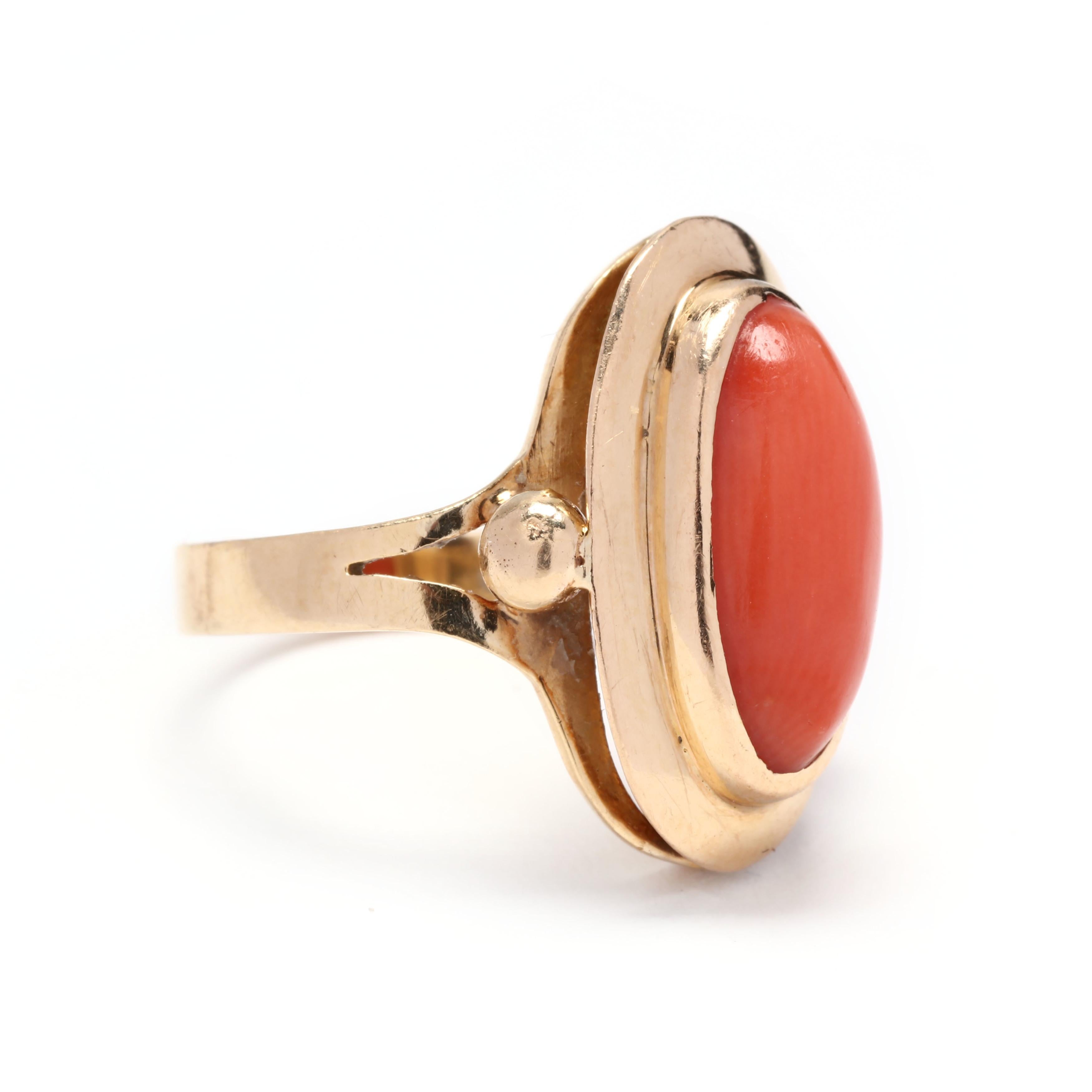 A vintage 18 karat yellow gold oblong oval coral ring. This ring features an oblong oval cabochon coral set in a stepped bezel and with a bead and split shank.



Stone:

- coral, 1 stone

- oval cabochon

- 13 x 6.5 x 3.98 mm

- approximately 2.45