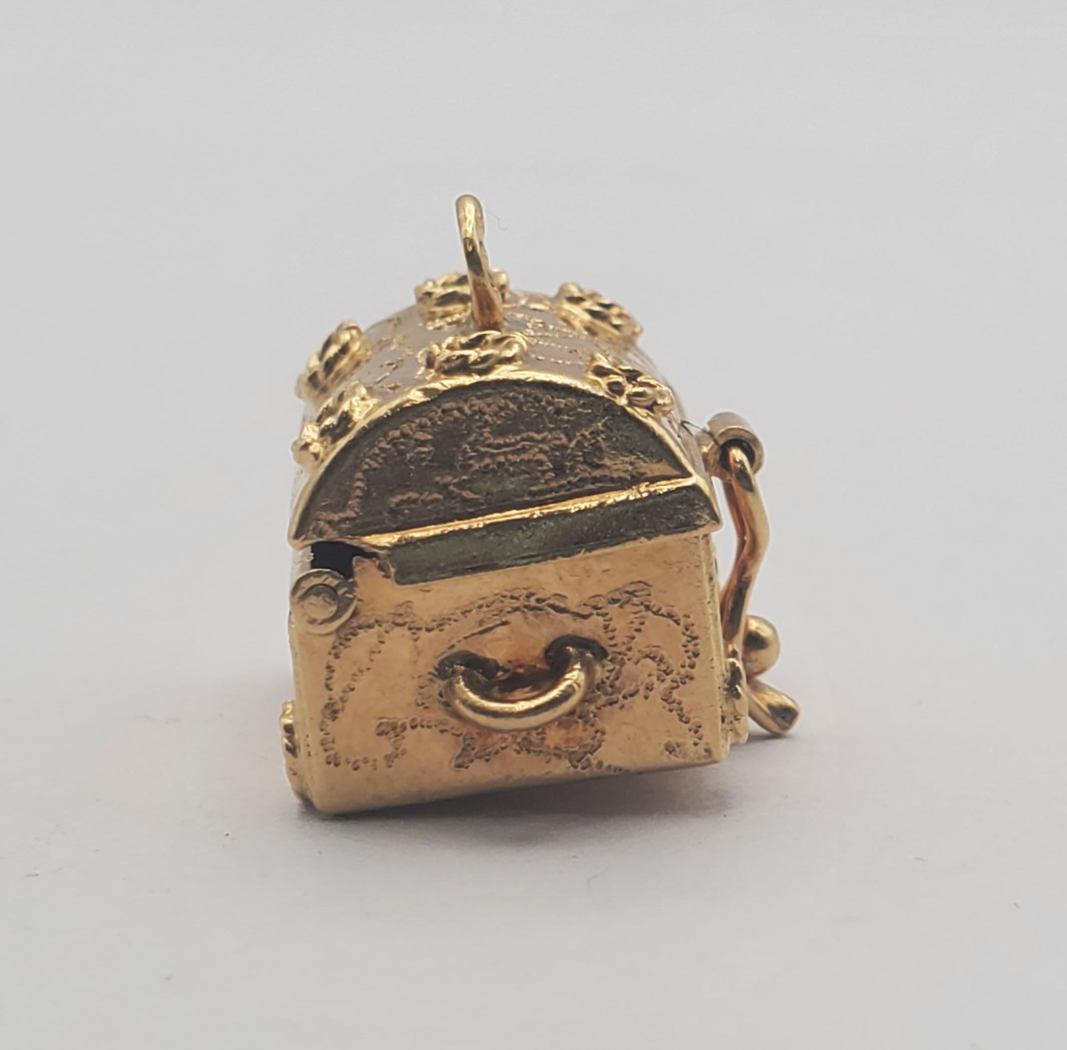 Beautiful vintage treasure chest charm/pendant featuring hidden pearl treasure inside. The chest is hinged and has a figure eight system to hold it closed. The bottom is engraved with the date 12-25-66. This chest would make an adorable pendant or