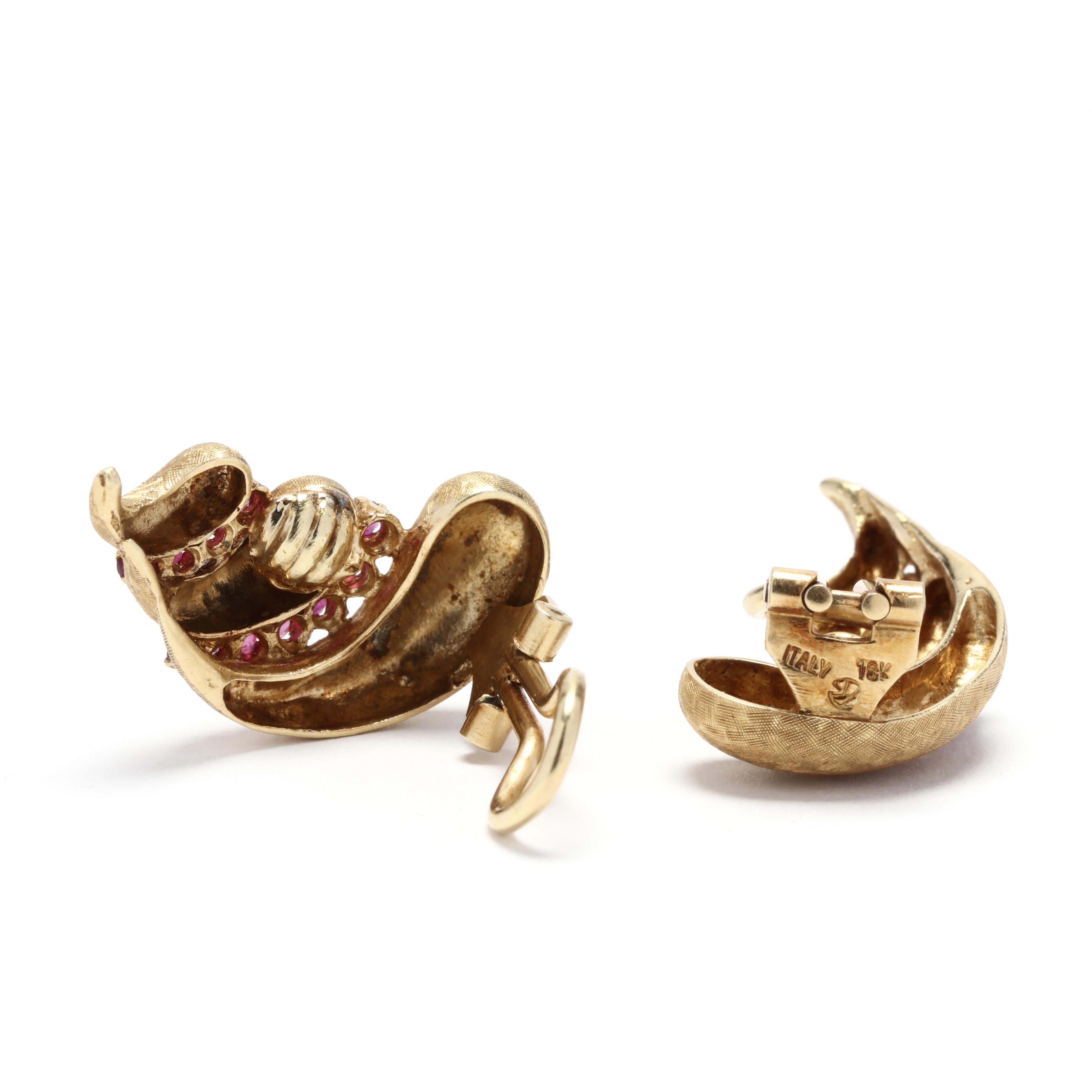 A pair of 18 karat yellow gold ruby shrimp clip on earrings. These earrings feature a textured shrimp design with prong set round cut rubies weighing approximately .76 total carats and with omega clip backs.



Stones:

- rubies, 22 stones

- round