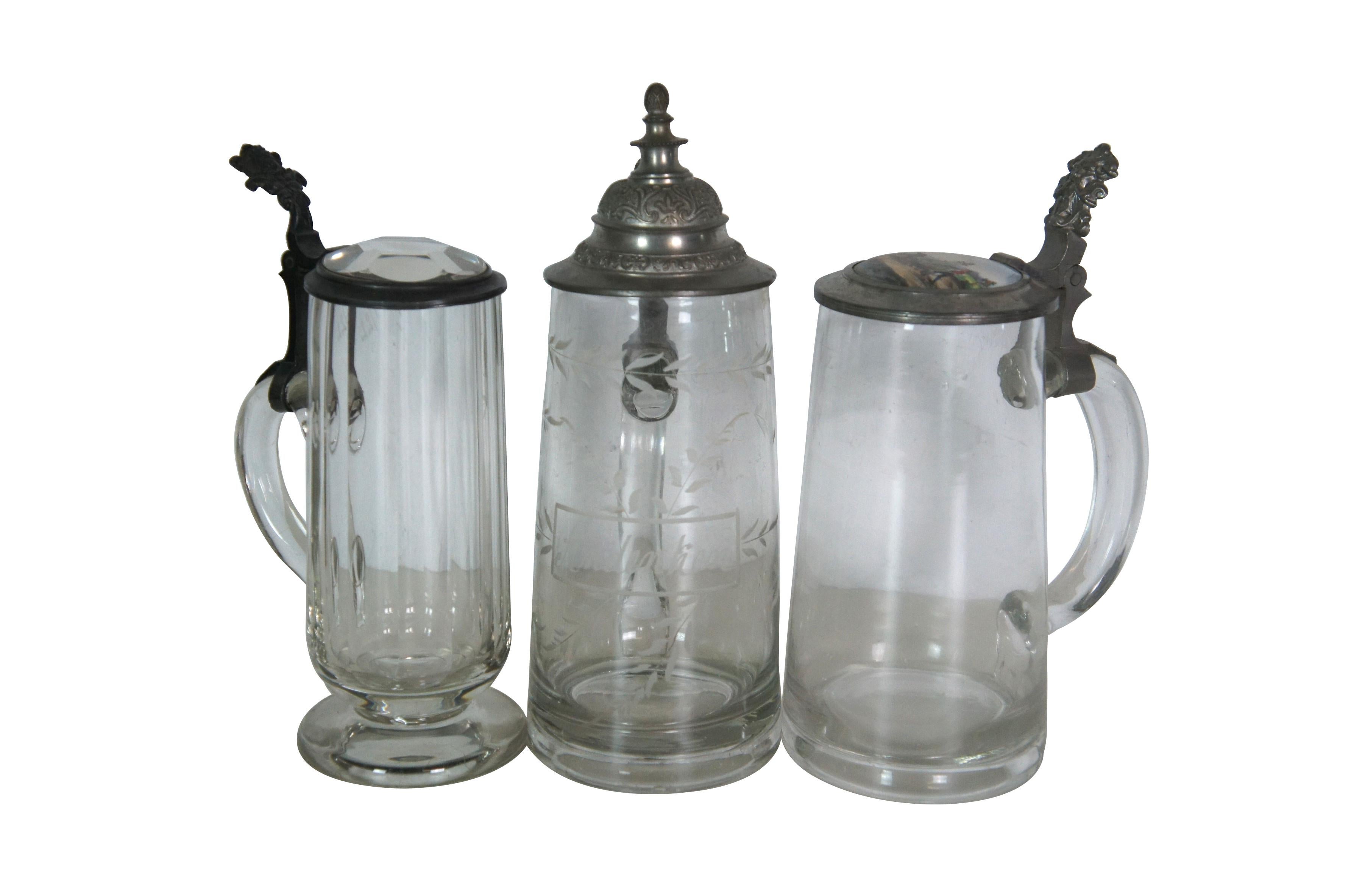 Lot of 19 rare early 20th century antique German cut / etched / faceted glass beer bar steins with metal / pewter flip top lids. Thumbprint, bubble glass, cut, and etched. Lids with painted / enameled glass or rhinestone finials - 8. Lids with