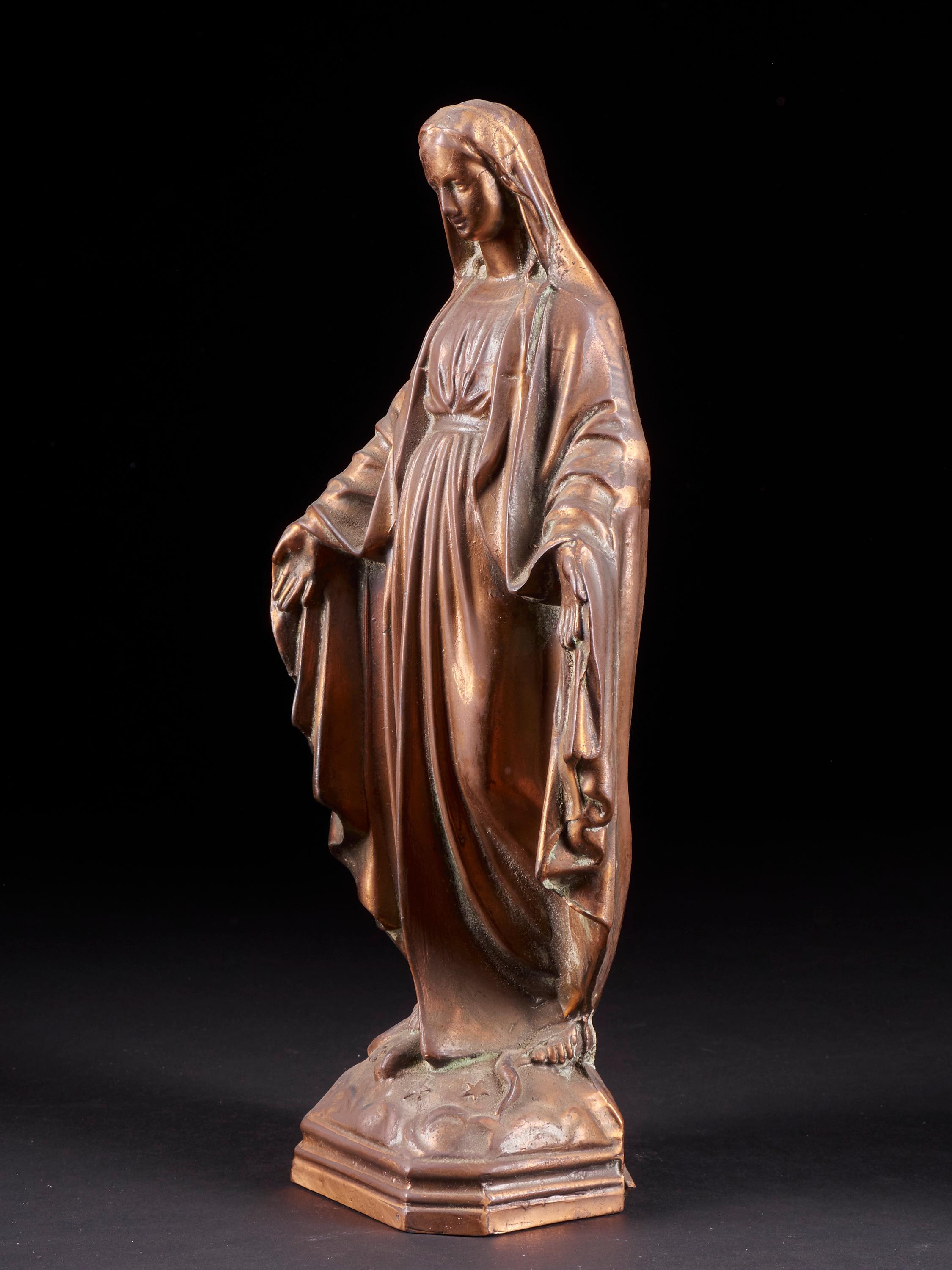 Delicate statue of Mary with open arms. The use of copper alloy enhances both features and drapes of Virgin Mary and highlights the patina. A charming piece of Folk Art.