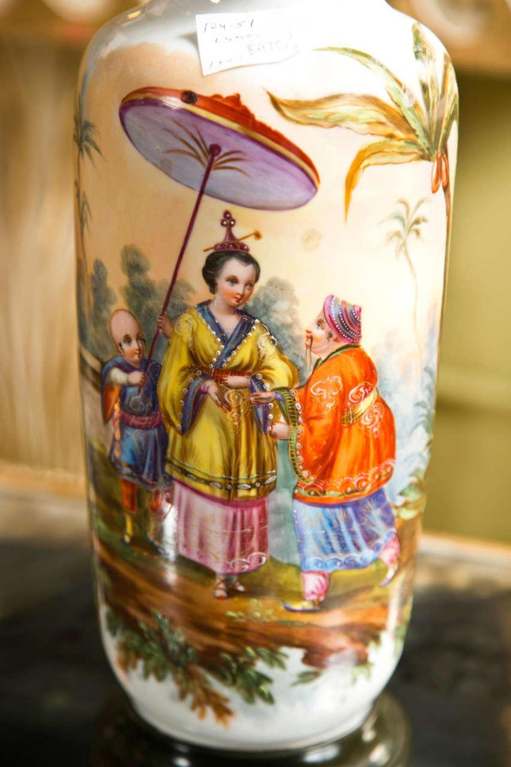 Pair of 19th century French Chinoiserie style porcelain lamps, hand-painted, jewel like, Chinoiserie scene of figures. Wonderfully decorated. The whole supported on a round wooden base. Shades measurement: 11 inches diameter. Shades not included.