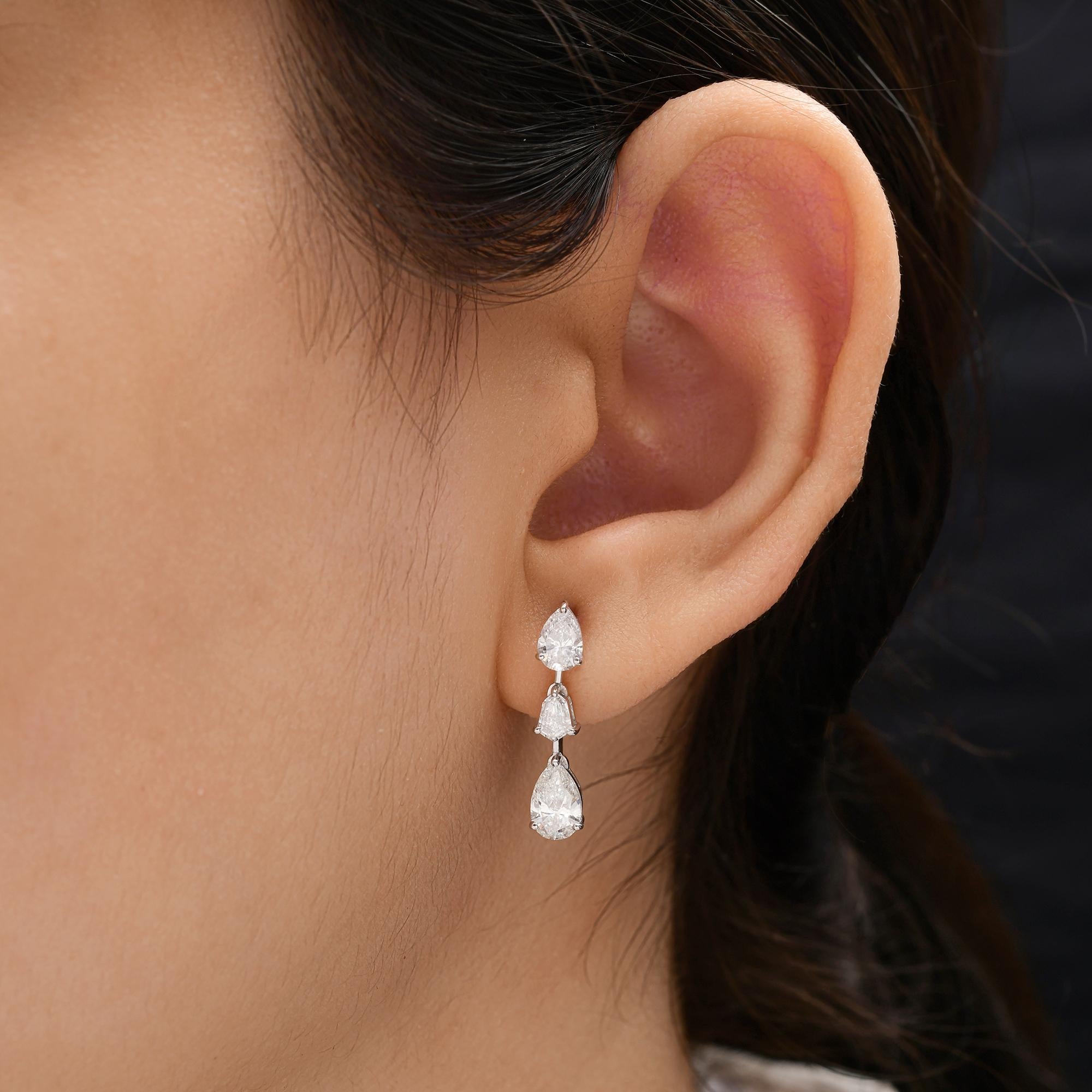 1.9 Carat Brilliant Cut SI/HI Triple Diamond Drop Earrings in 18K White Gold 
The design showcases three delicately linked diamonds—starting with a brilliant pear-cut stud at the top, followed by a geometric trapezoid-cut center stone, and ending