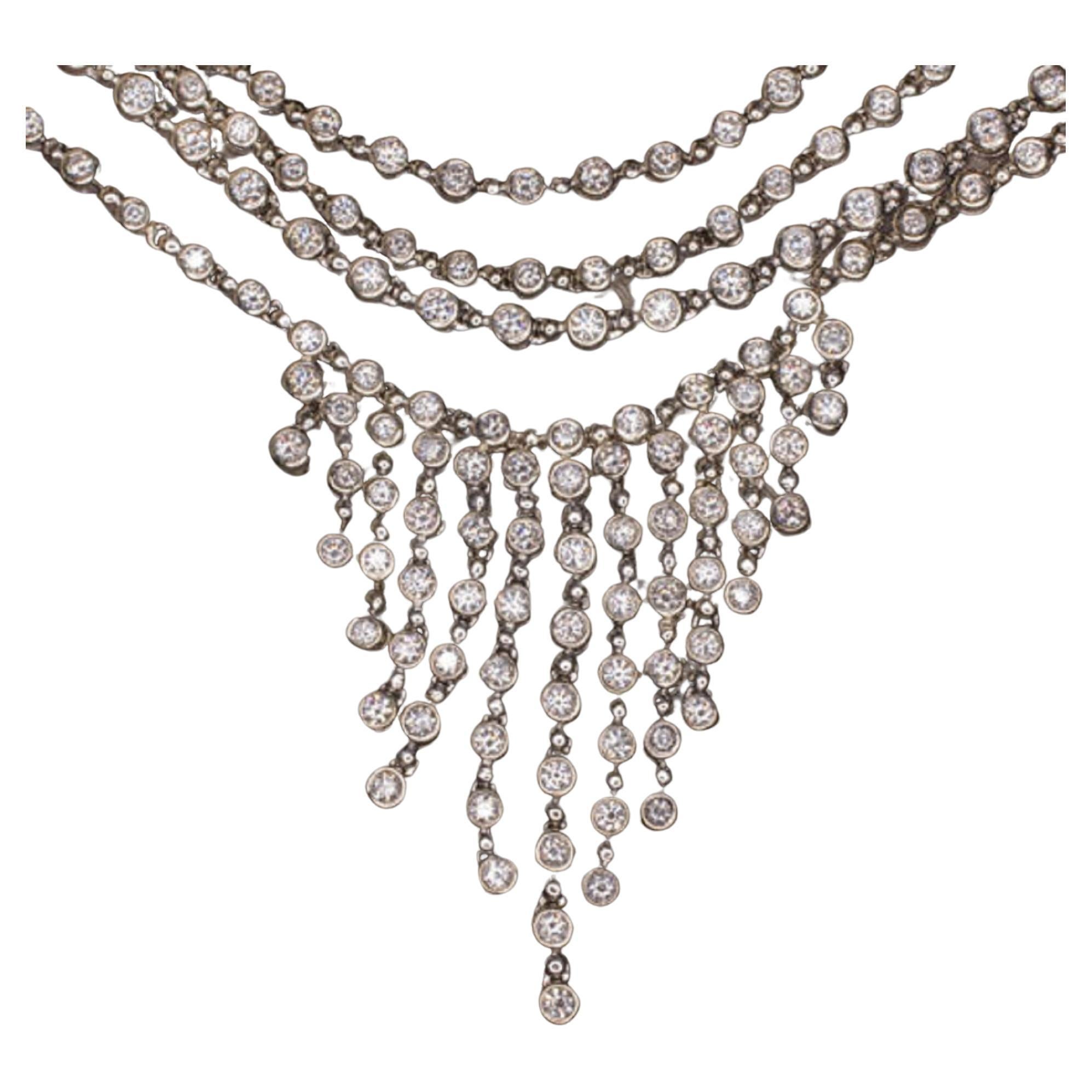 This incredible diamond necklace positively radiates elegance, class, and luxury! Four strands and 19.20 carats of brilliantly white natural diamonds form a shimmering stream which cascades gracefully into an exquisite diamond tassel. The tassel has