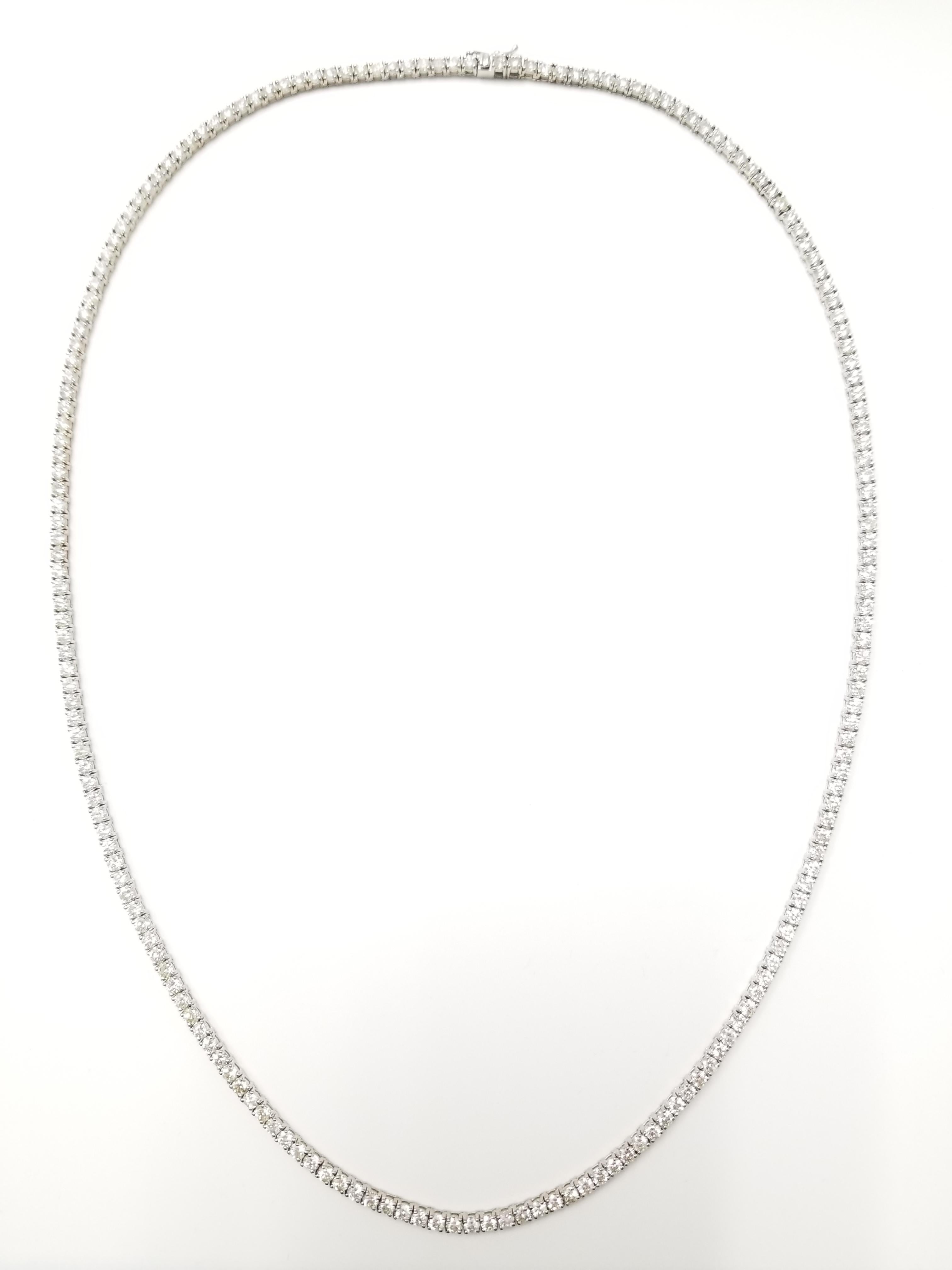 Stunning looking 14 Karat White Gold Round Brilliant Cut Diamond Tennis Necklace set on 4 prong setting. The total diamond weight is 19 carats. The closure is an insert clasp with safety clasp. Length is 24 inches. Amazing holiday gift or treat for
