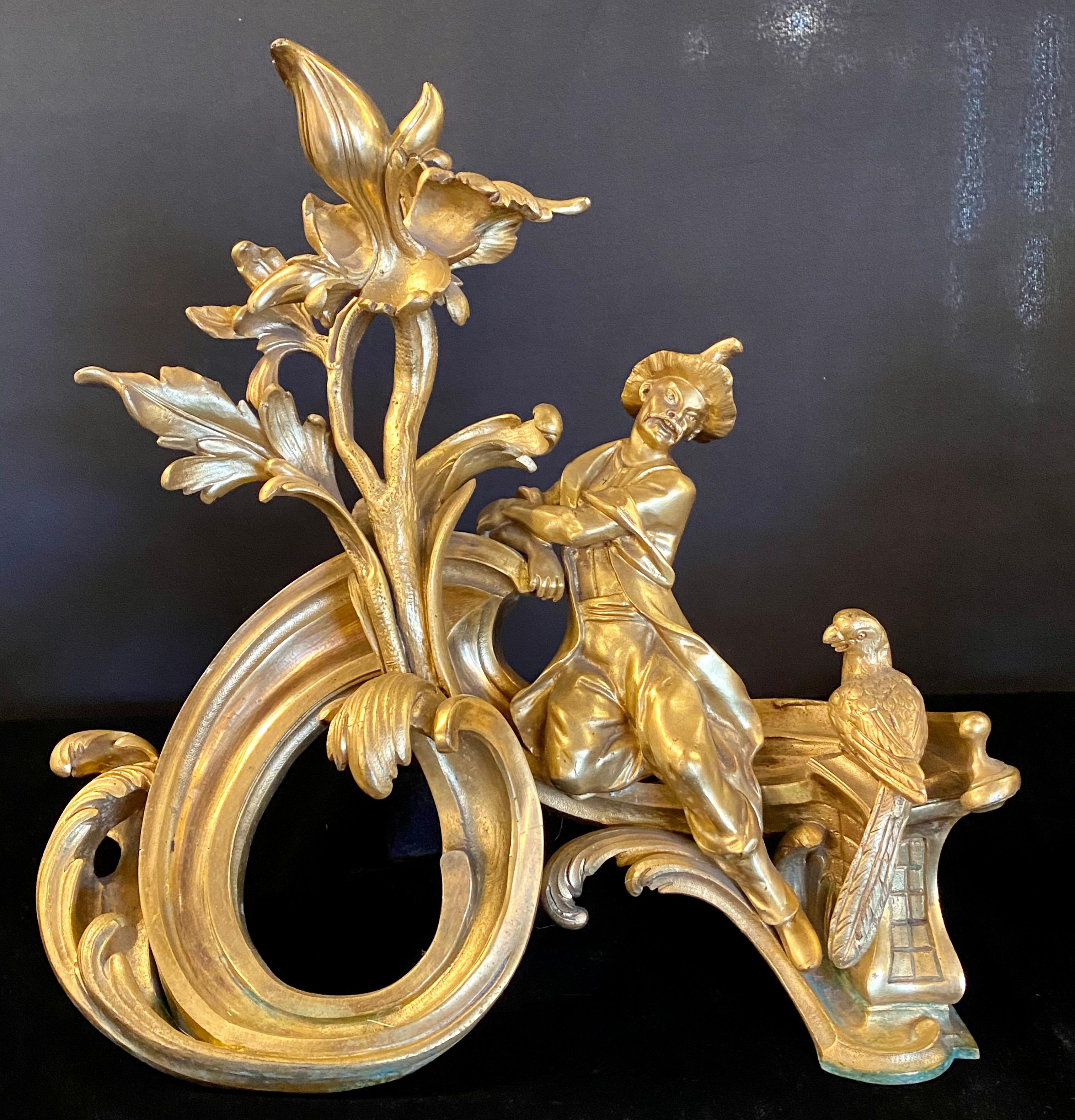 19th century pair of dore bronze chenets andirons signed bird with man and woman. A spectacular pair of dore bronze chenets or andirons each depicting a long tailed bird with seated Asian man and woman. (Description Sothebys NY formally Park Bennet