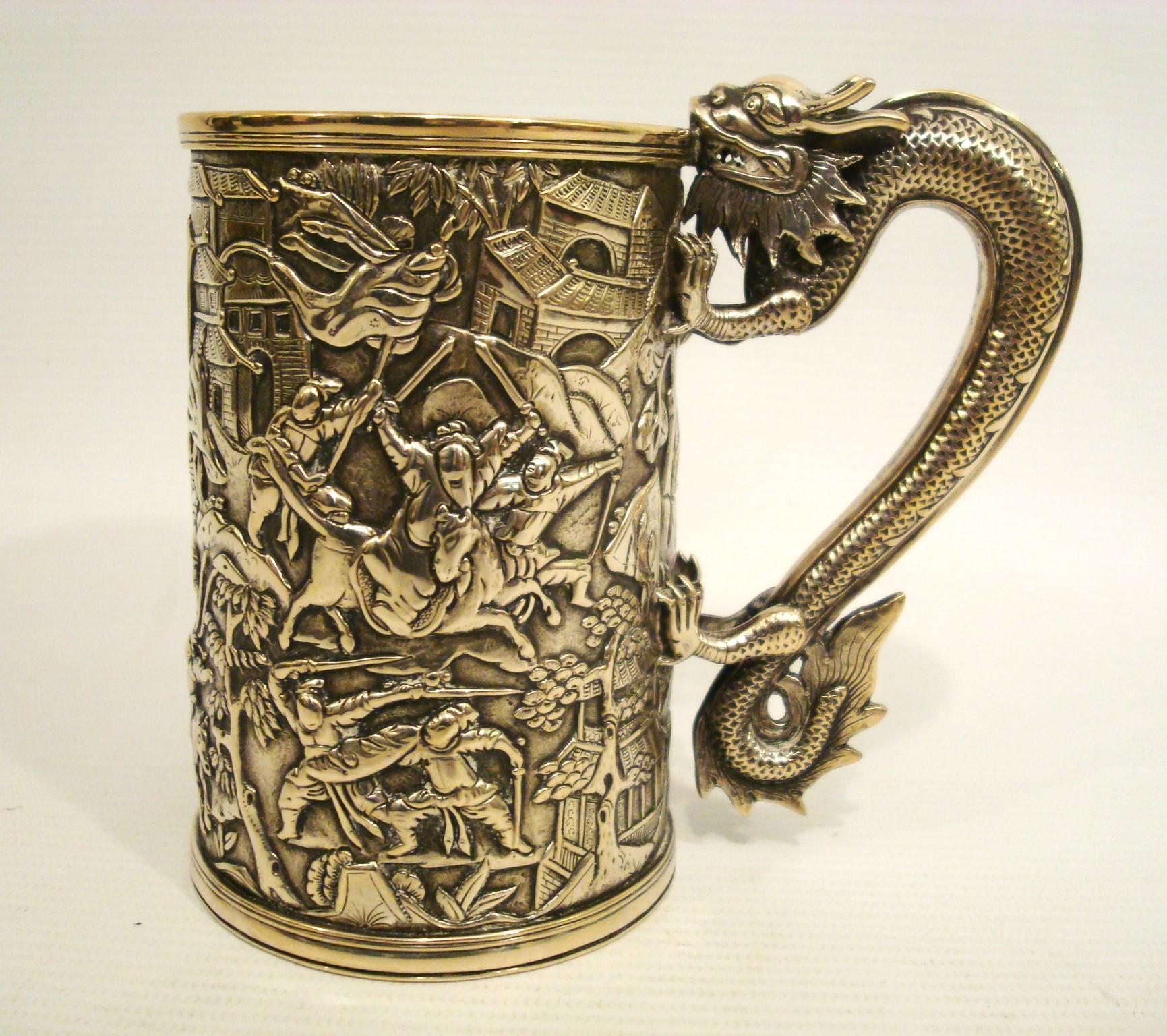 19th Century Chinese Export Silver Mug / Tankard, the sides are beautifully decorated in relief with a scene of warriors in combat, very crisp and detailed, centering a shaped cartouche for initials. The handle is beautifully modelled like a