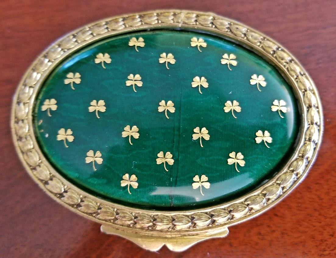 Gorgeous little gilt metal ring box with green enamel on lid with golden four leaf clovers for ‘Luck’.

Irish, hence the lucky clovers, from circa 1880.

Interior is lined with padded fabric to protect jewelry from damage.

Green guilloche