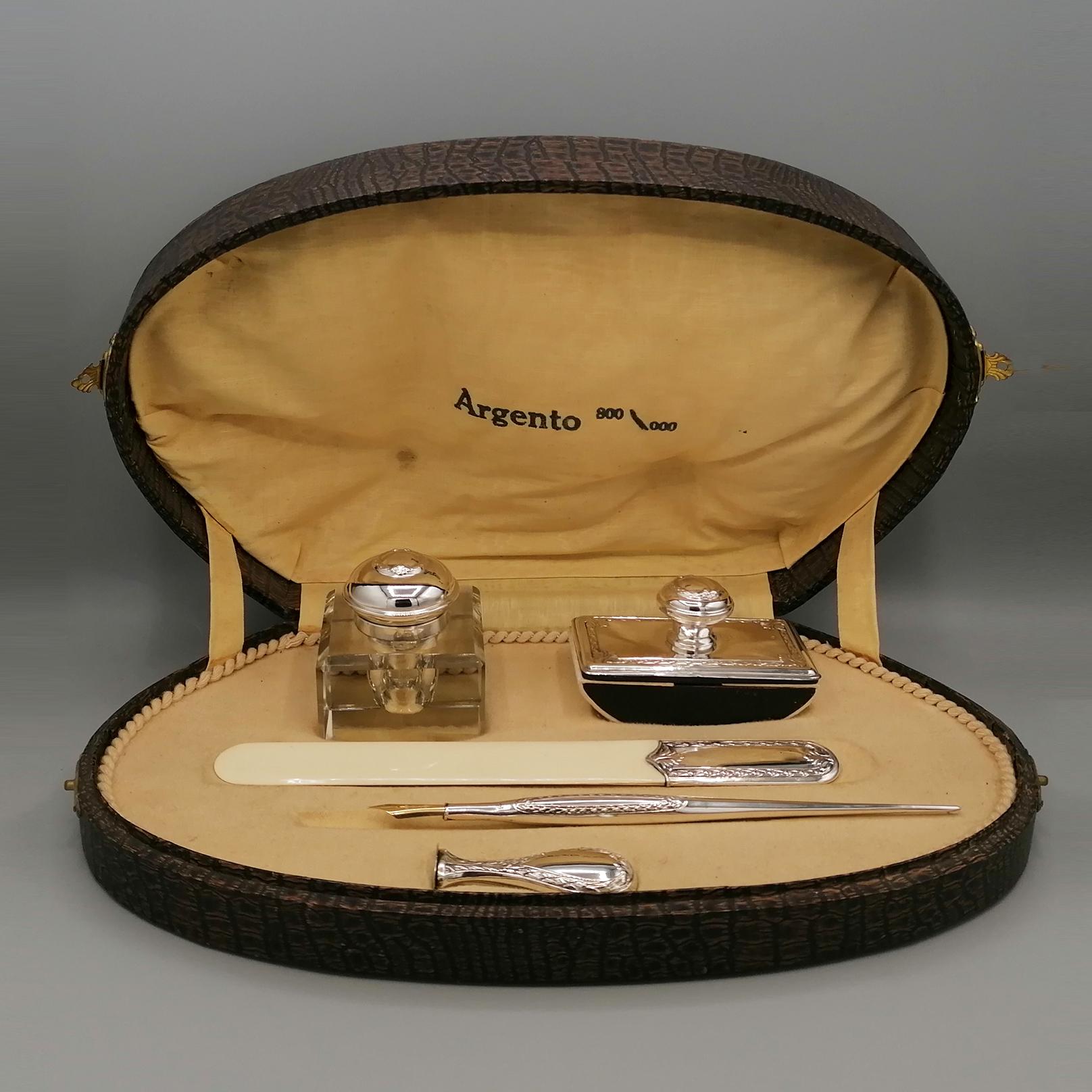 Italian desk set in 800/1000 silver late 1800s. 
The set consists of:
Square-shaped ground crystal inkwell with hinged silver lid and 24kt gold finish inside .
Rectangular pad with silver knob and plaque.
Letter opener in with silver handle
Pen with