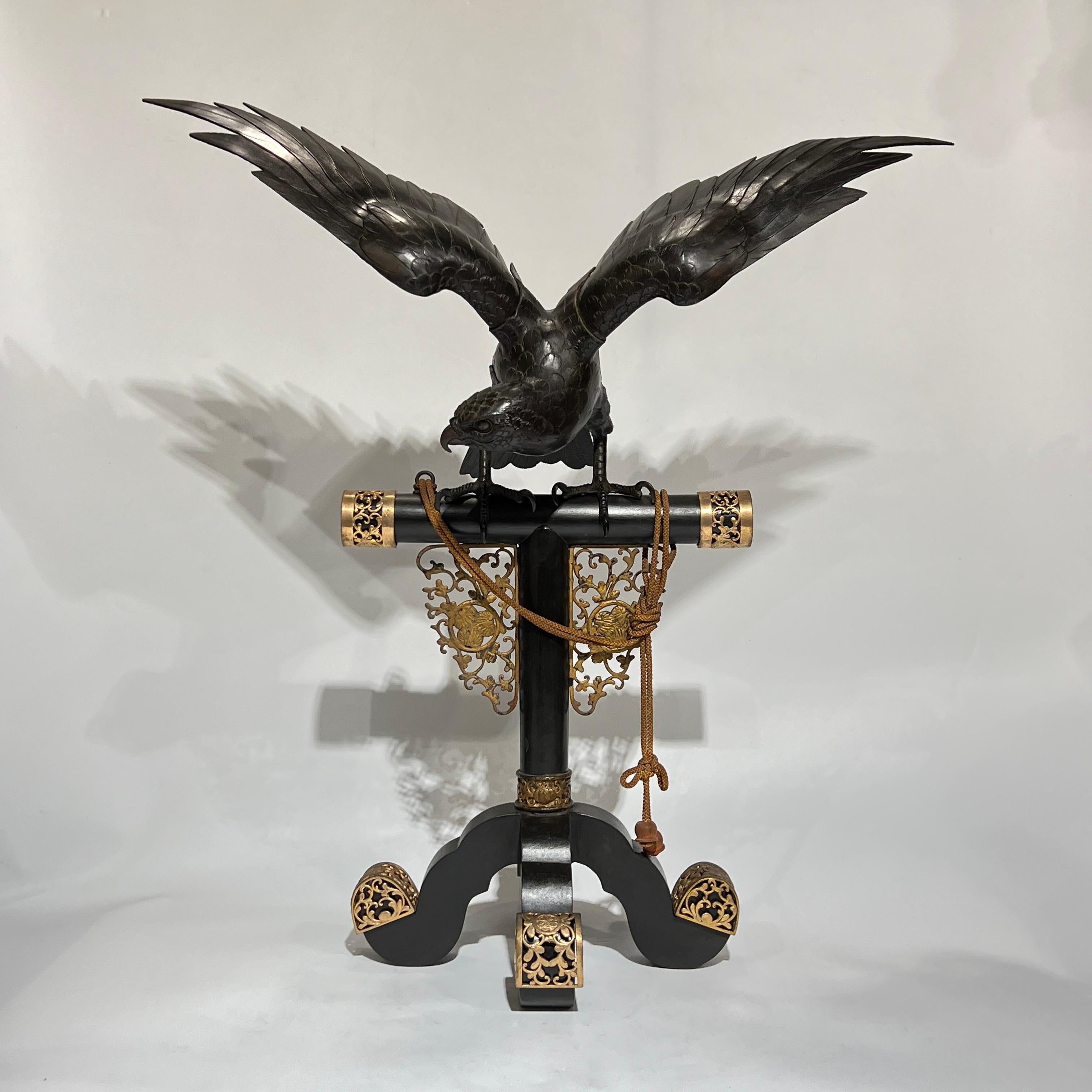very fine quality 19 century Meiji period  Japanese Bronze Hawk Sculpture on PedestalFinely sculpted and cast, patinated bronze figure of a hawk or other bird of prey, perched on a bronze  stand with bronze mounts and cord with tassel.