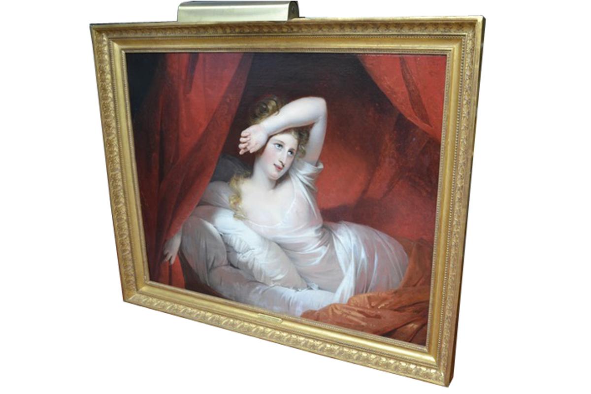 A beautifully executed oil painting of a young lady awakening from her lavishly draped bed, her left arm partially covering her face possibly against the morning sun. She is clothed in a diaphonous white night gown and lays back against her