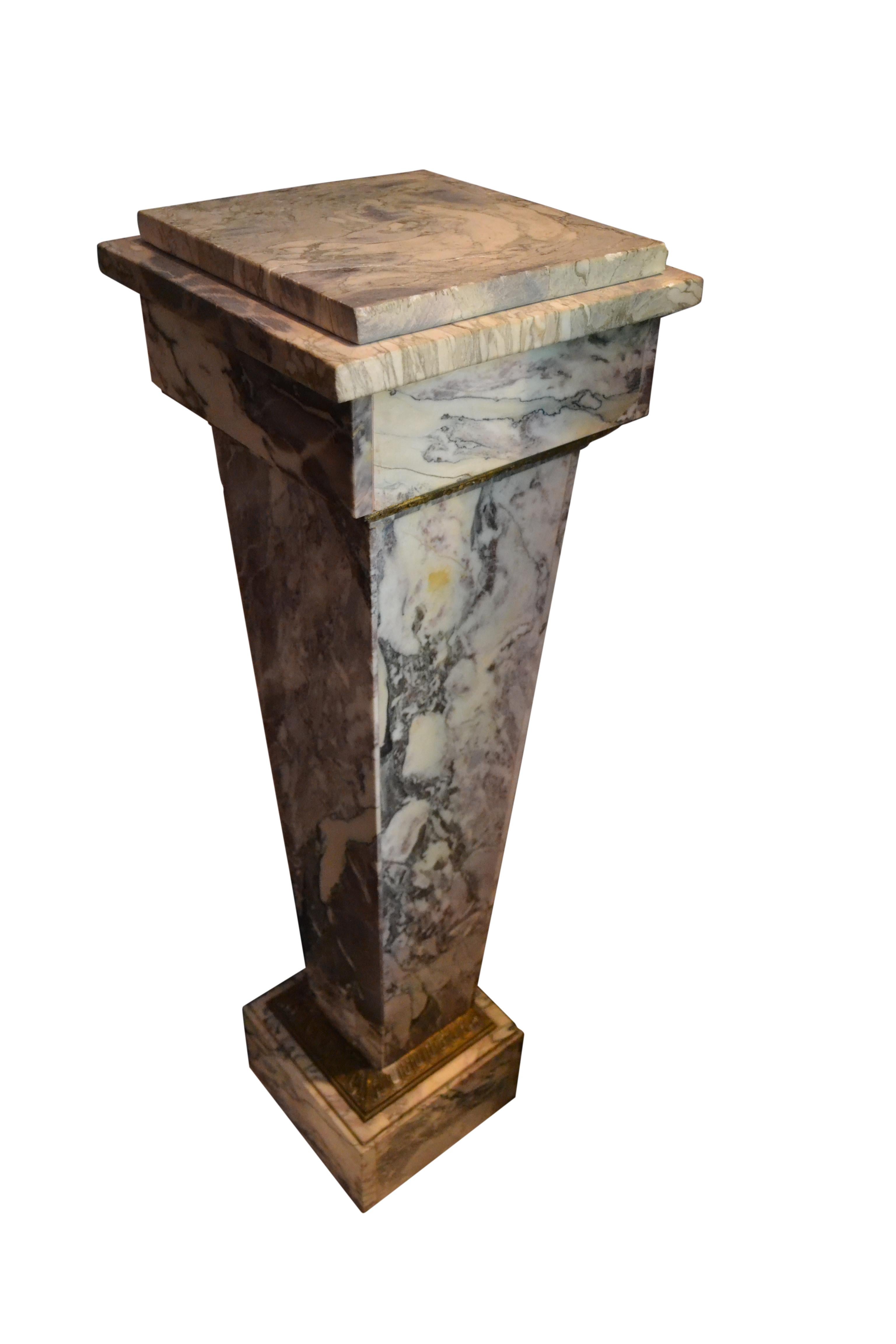 A late 19 century tapering square column made of a white flourite marble called 'Lilac'. It is heavily veined in brown and black on a white background with touches of light red/lilac colour. Below the rectangular top there is a gilt bronze banding