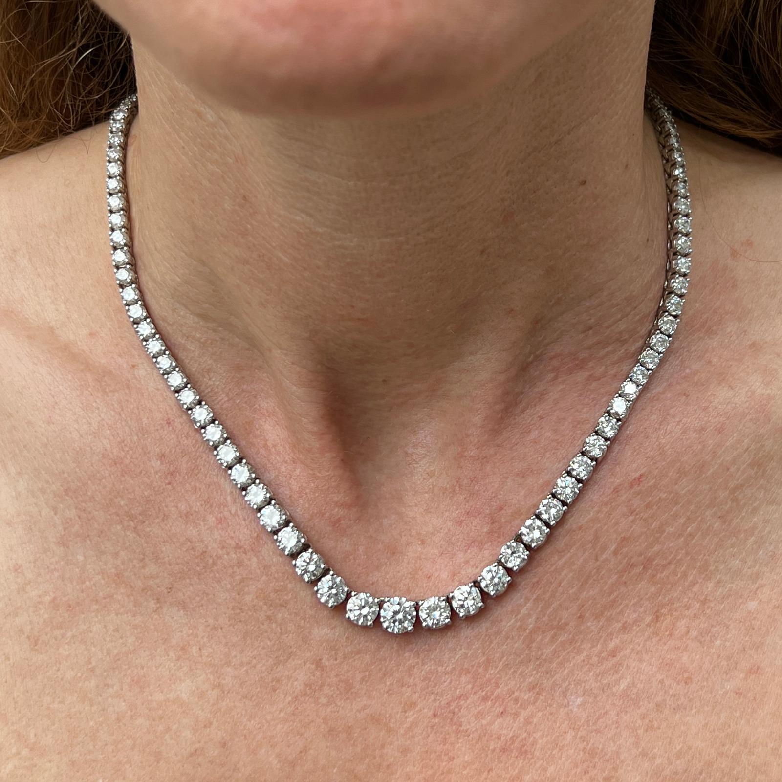 Gorgeous diamond riviera necklace crafted in 14 karat white gold. The necklace features 132 round brilliant cut diamonds weighing 19.04 carat total weight. The diamonds are graduated with the largest diamond weighing approximately .95 carats. The