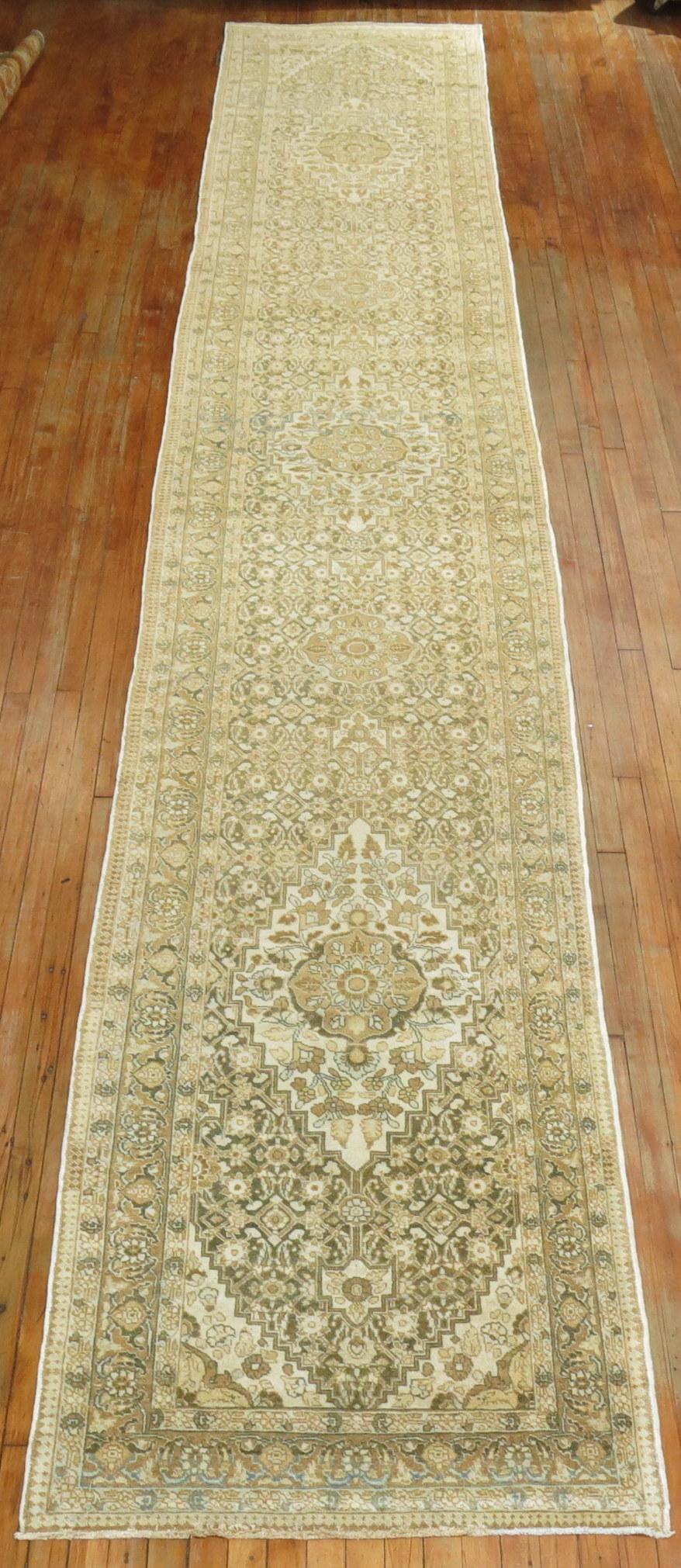 Antique Persian Tabriz runner. Predominantly Ivory, green and brown accents with 3 medallions on a Herati ground, circa 1920

Measures: 3'3” x 19'4”.