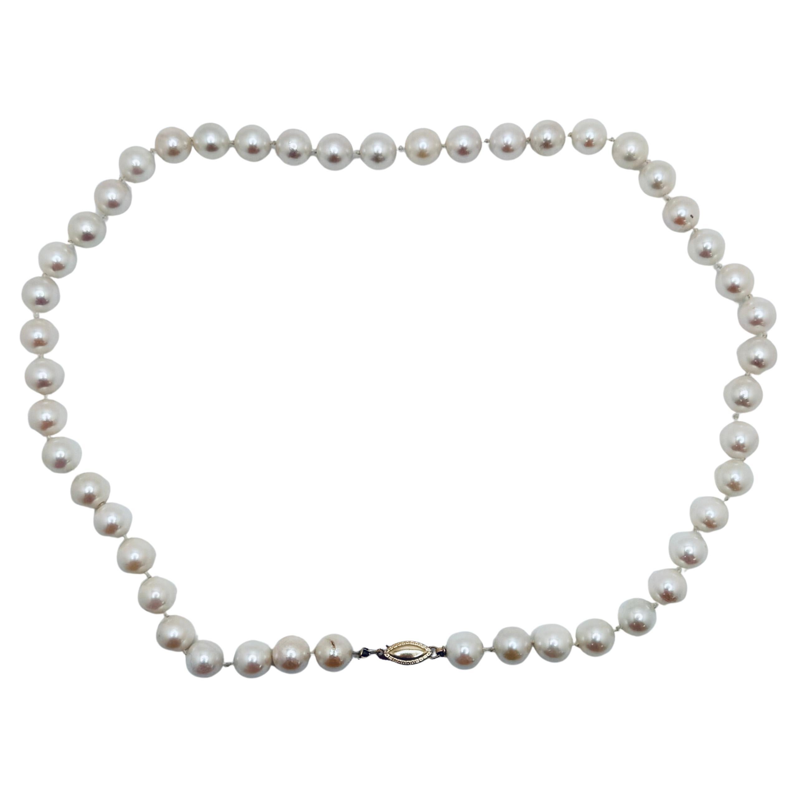 This classic freshwater pearl necklace features 47 lustrous pearls in a soft cream hue, offering timeless elegance. Each pearl measures approximately 8.5 to 9.0mm in diameter, displaying a consistent round shape and smooth surface. The necklace is