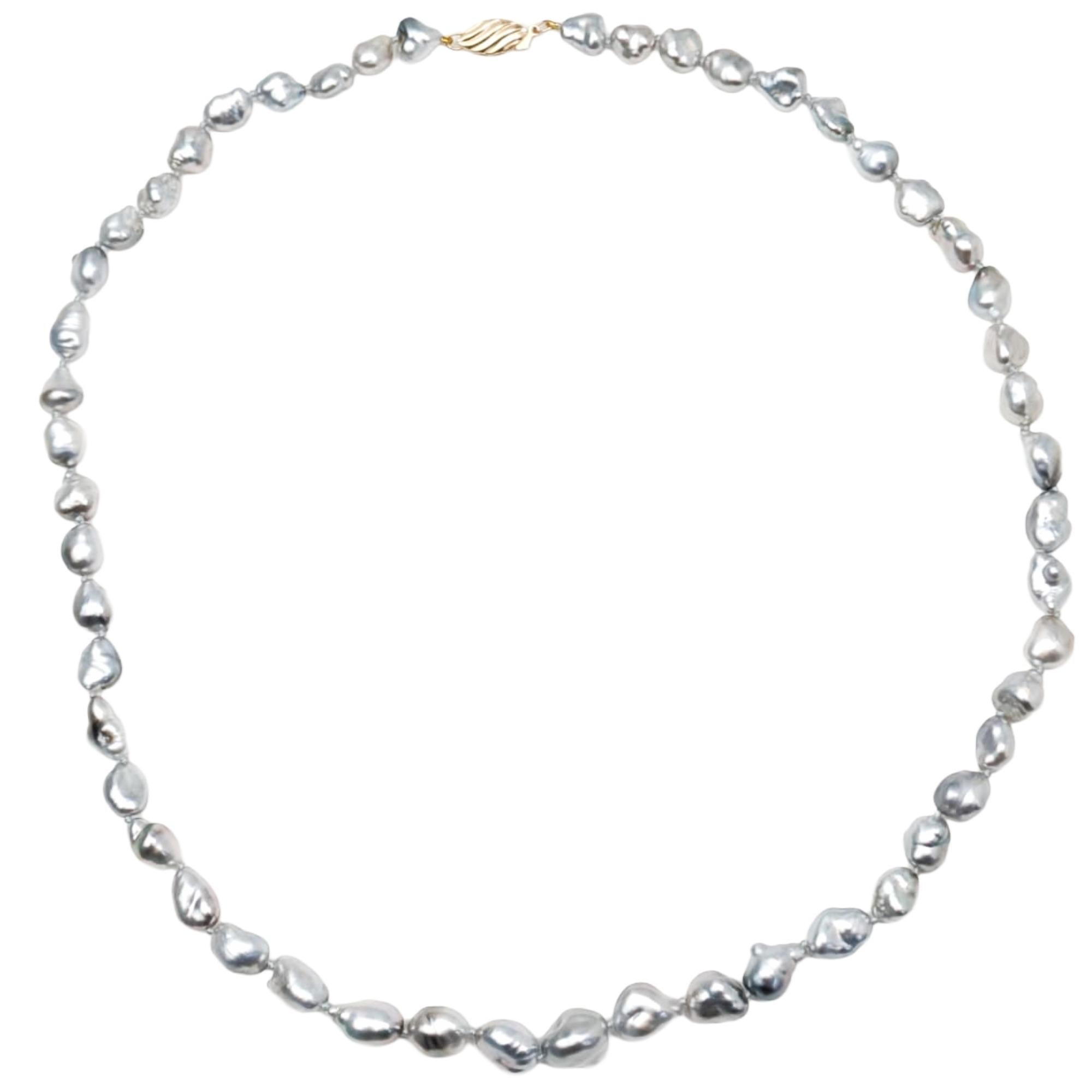 Organic, luminous, and effortlessly elegant, this 19-inch grey keshi pearl necklace celebrates the natural beauty of free-form pearls. Each keshi pearl is unique in shape and character, offering soft silvery-grey tones and an iridescent sheen that