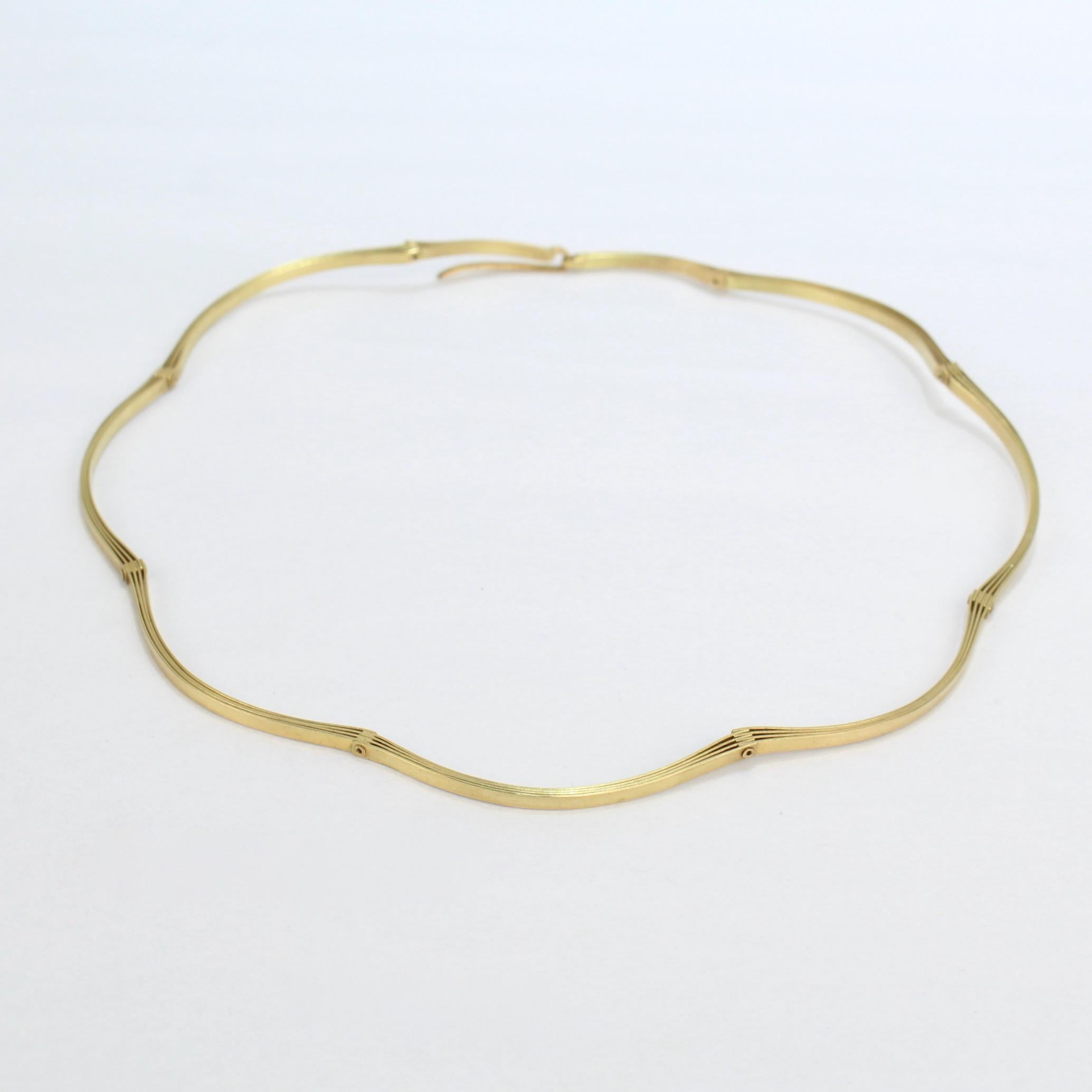 A very fine Modernist 19k gold handmade choker necklace.

Each link is comprised of three layers of gold strips riveted together with moveable hinges.  

Simply a great piece of artisan or studio jewelry!

Date:
20th Century

Overall Condition:
It